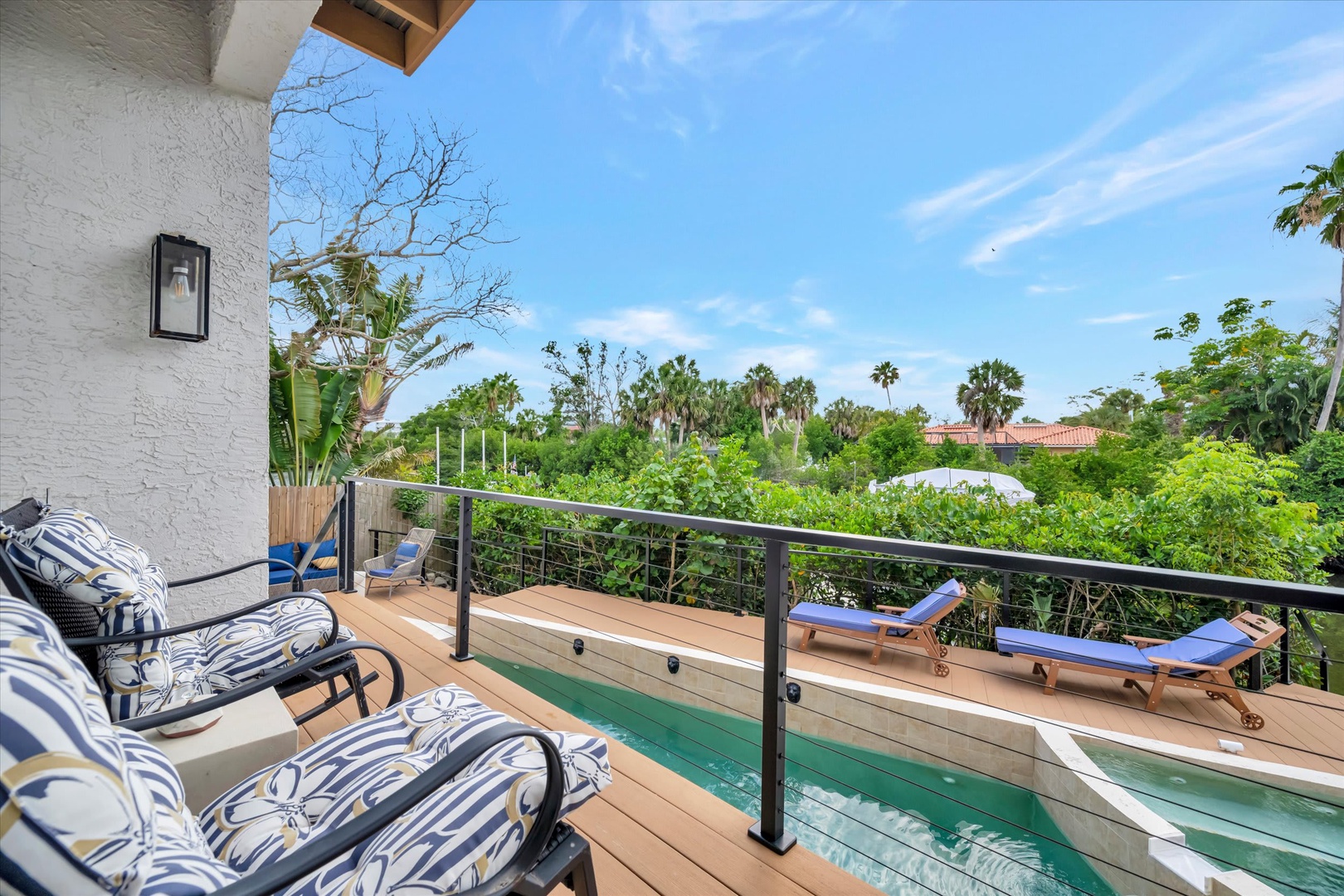 Picture yourself lounging on this spacious deck, soaking up warm rays by your private lap pool, surrounded by lush tropical greenery and swaying palms—your perfect retreat awaits.