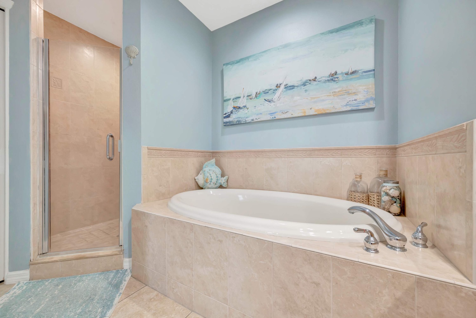 Slip into your private soaking tub after a long day, or refresh in the spacious walk-in shower. Soft coastal tones and beachy décor create a calming retreat where you can unwind completely.