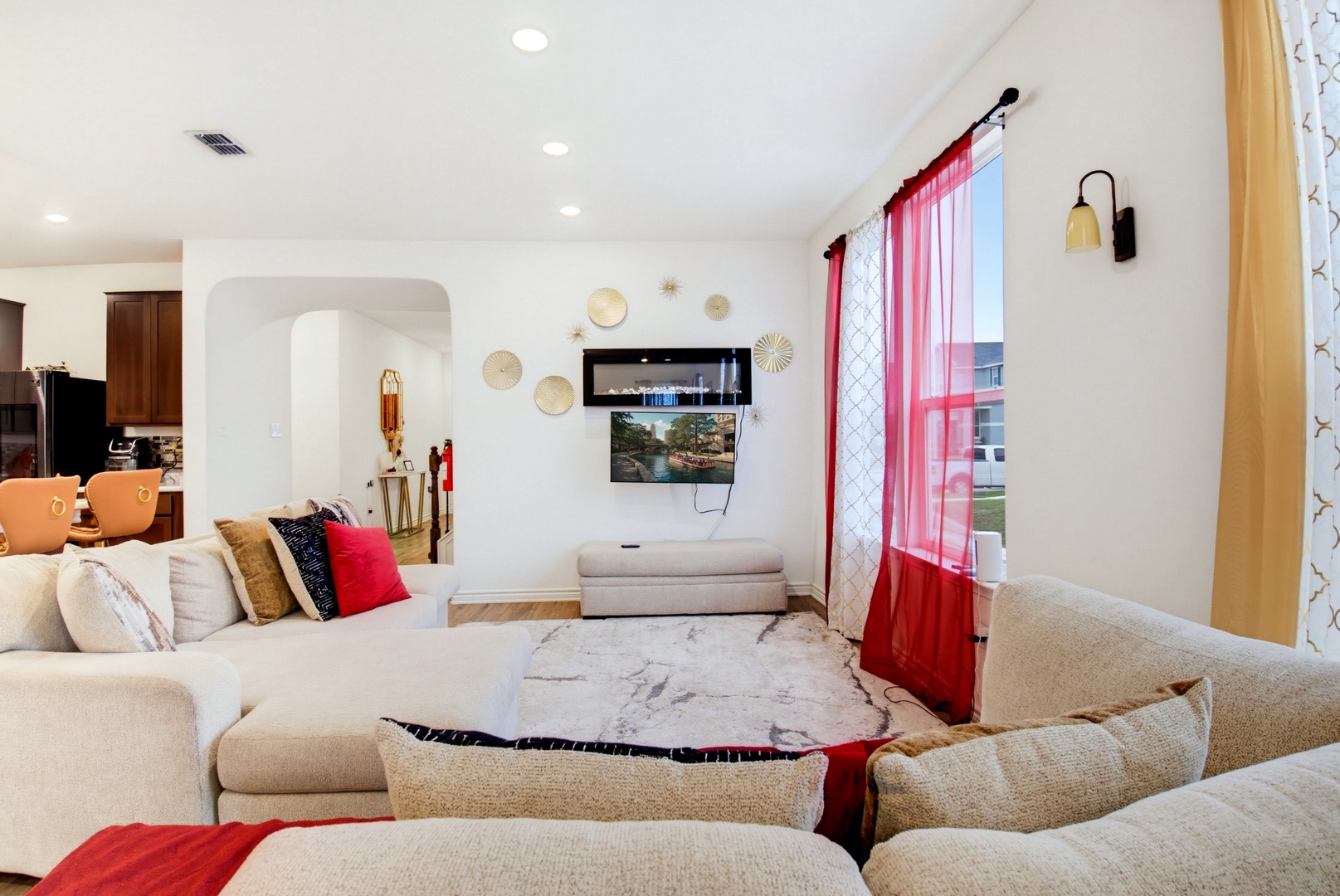 Sink into plush seating and unwind in your bright, beautifully styled living room with vibrant touches of color and modern comfort.