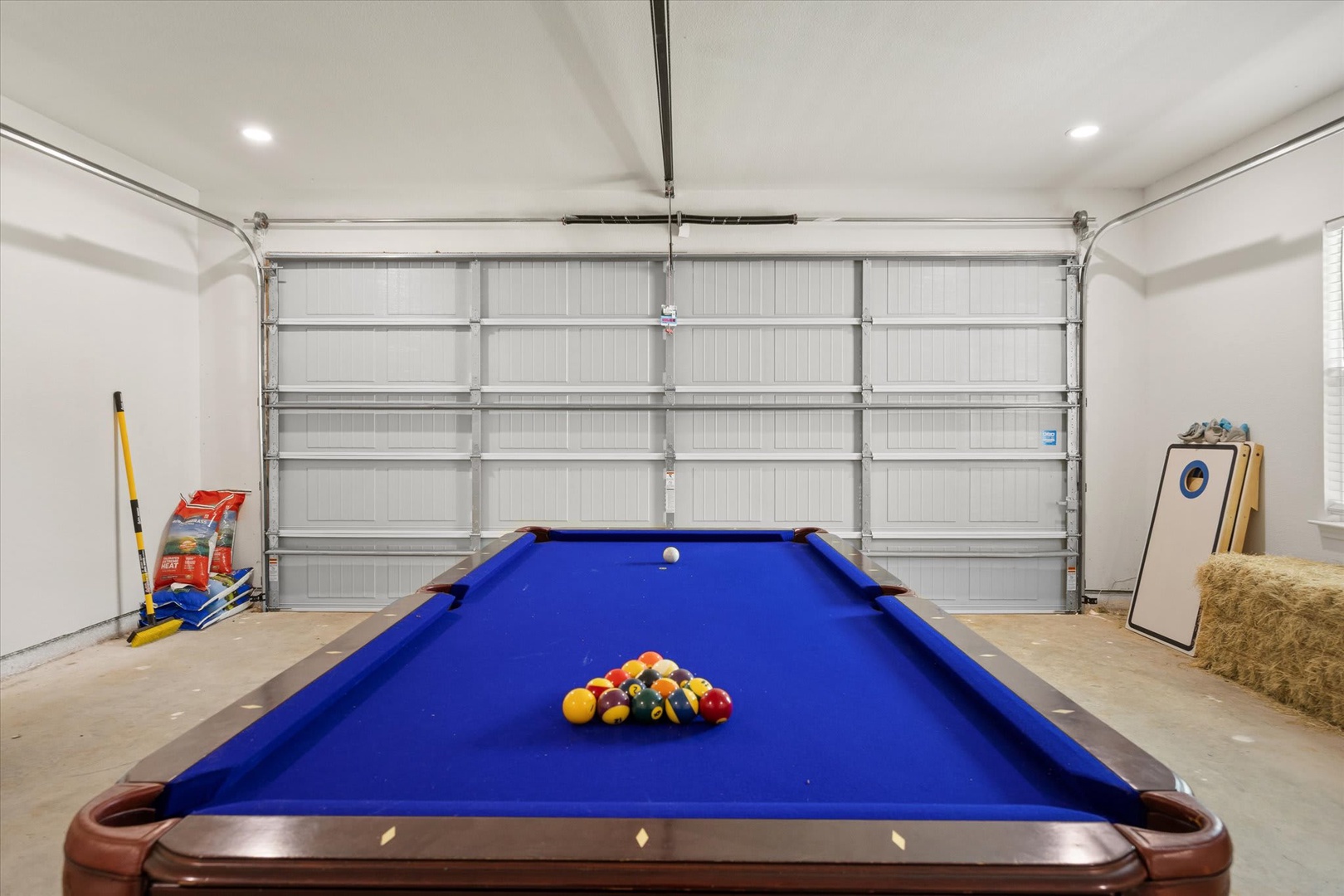 Challenge friends to a friendly game on the full-sized pool table in your private game room, with everything racked and ready for your next match.