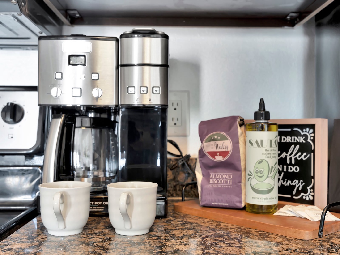 Your morning routine starts here with a thoughtful coffee station, complete with a dual-brew system and Italian biscotti waiting to be savored—everything you need for that perfect first cup.