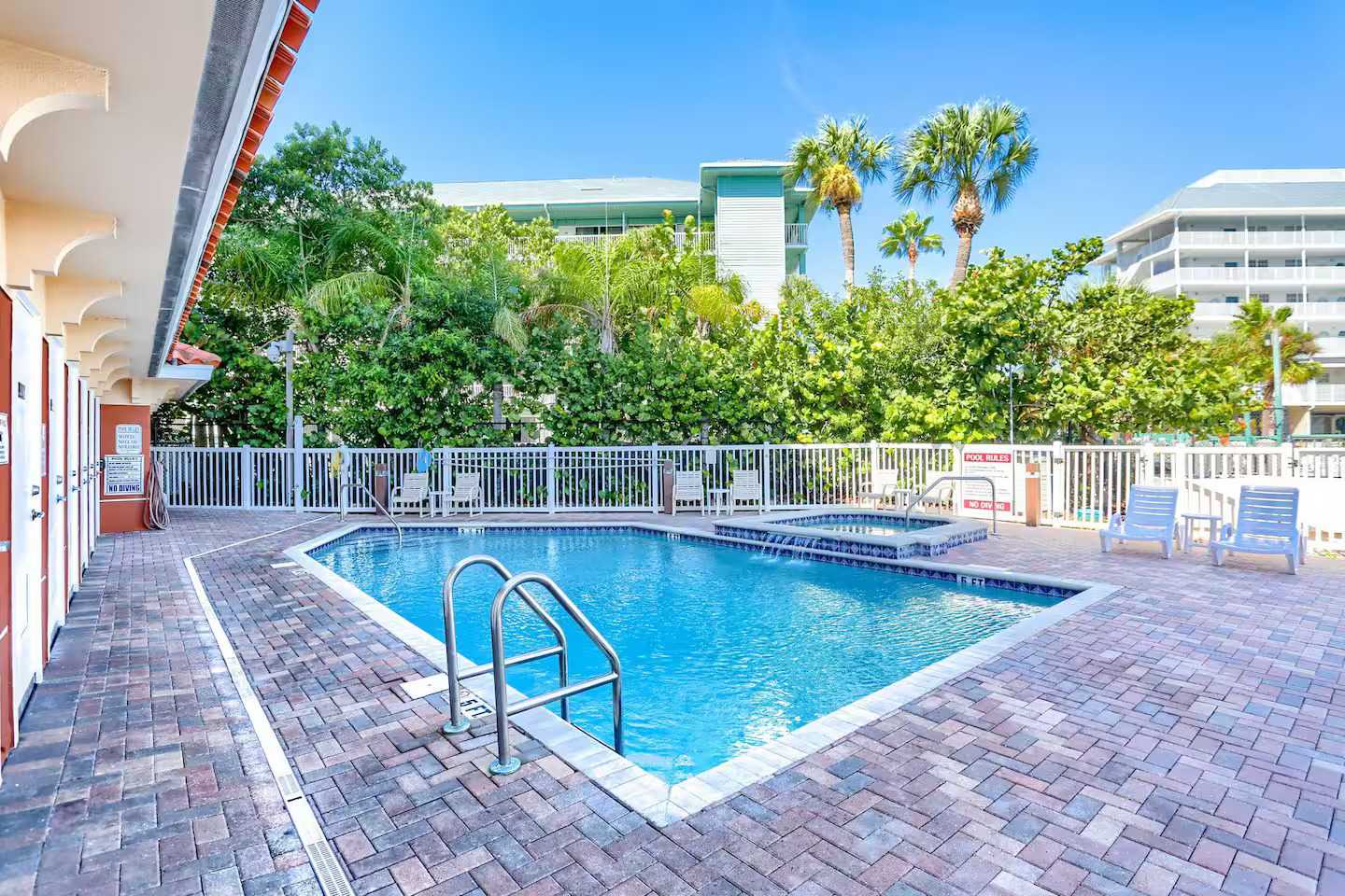 Soak up the Florida sunshine at the sparkling outdoor pool, surrounded by lush palms and tropical landscaping, perfect for refreshing dips and lounging in paradise.