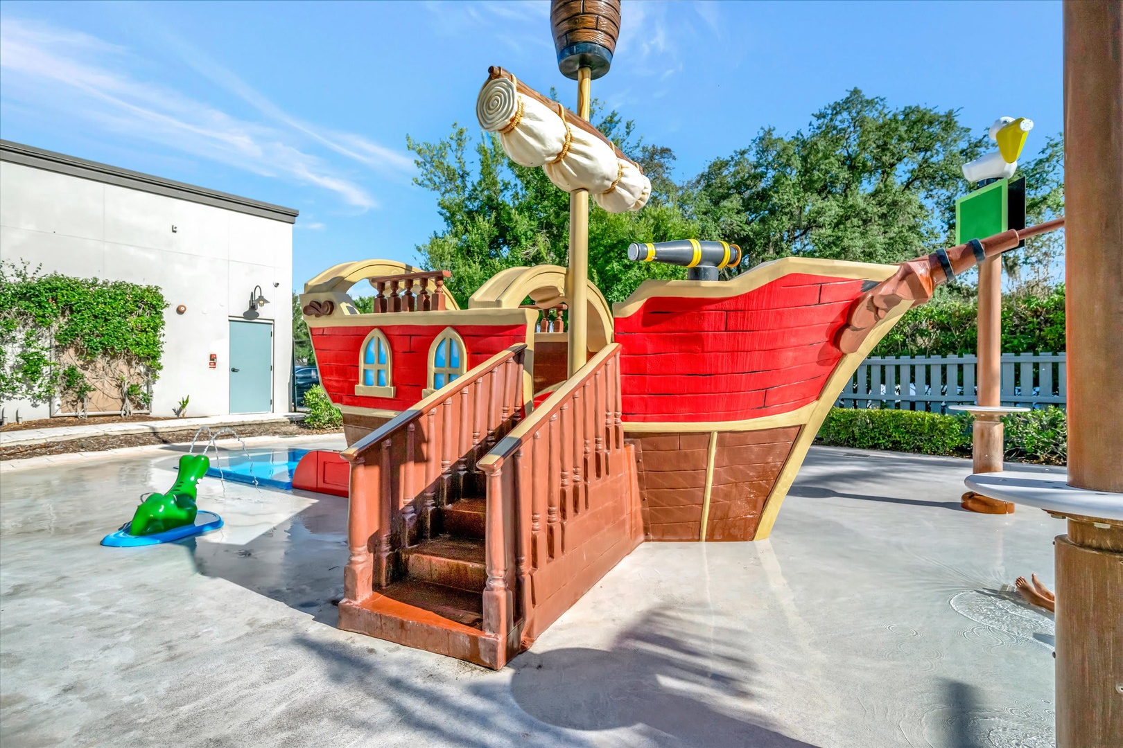 A colorful pirate ship playground awaits young adventurers, complete with telescopes and climbing features—perfect for sparking imaginative play under sunny skies.
