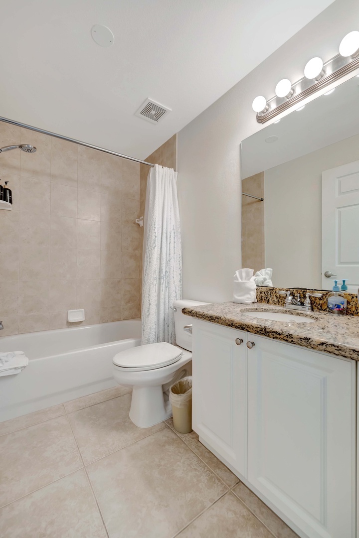 Freshen up in your private bathroom with a shower-tub combo, bright vanity lights, and a granite countertop with plenty of space for your essentials.