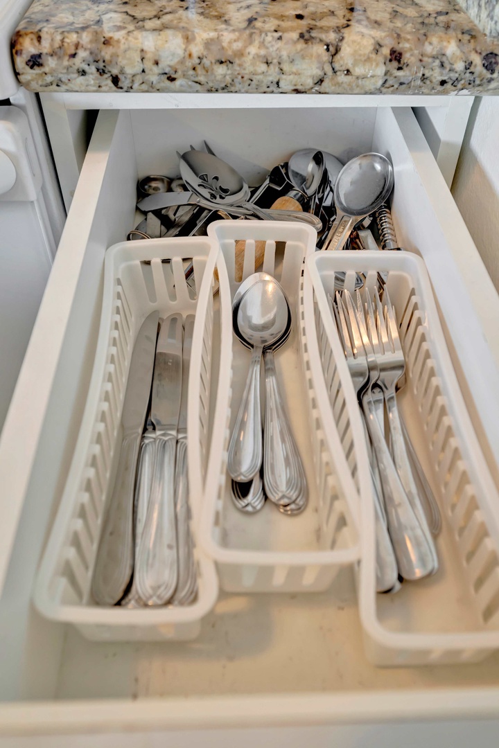 Your kitchen is fully equipped and ready for preparing meals, with organized utensils, serving spoons, and all the essentials neatly arranged in the drawer for easy access.