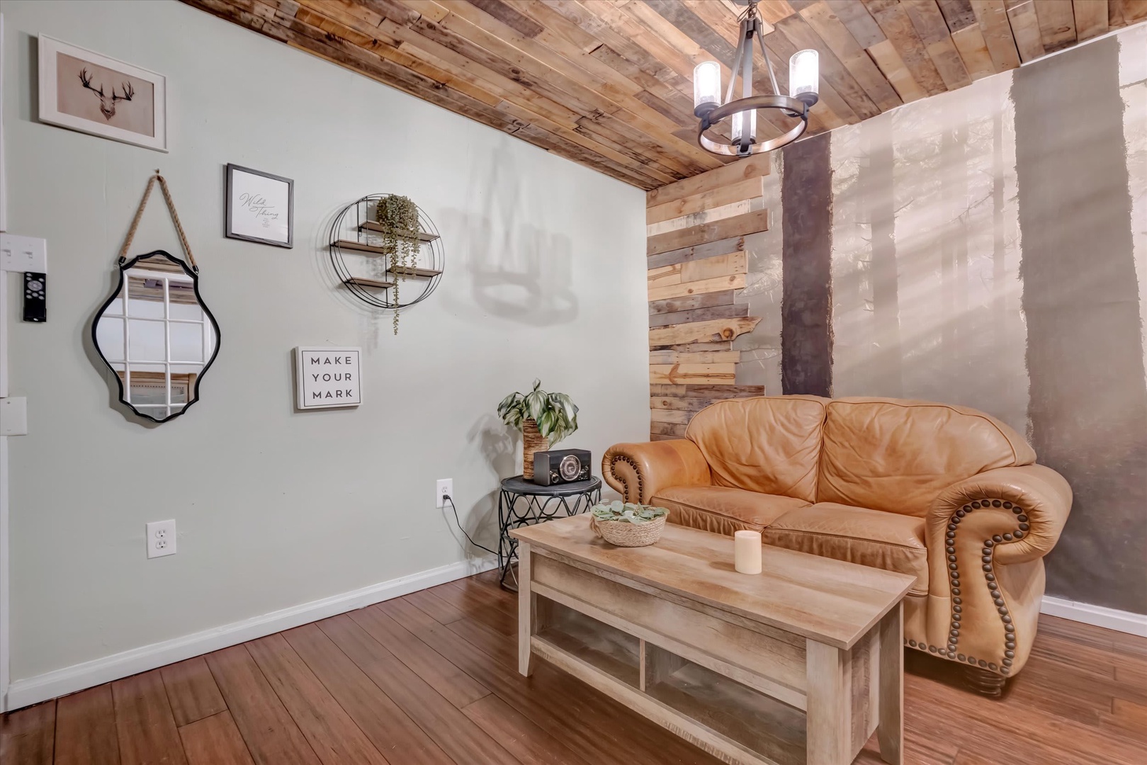 Sink into plush leather comfort in your private living space. The rustic wood ceiling and eclectic wall décor create a warm, homey vibe where you can unwind after exploring the area.