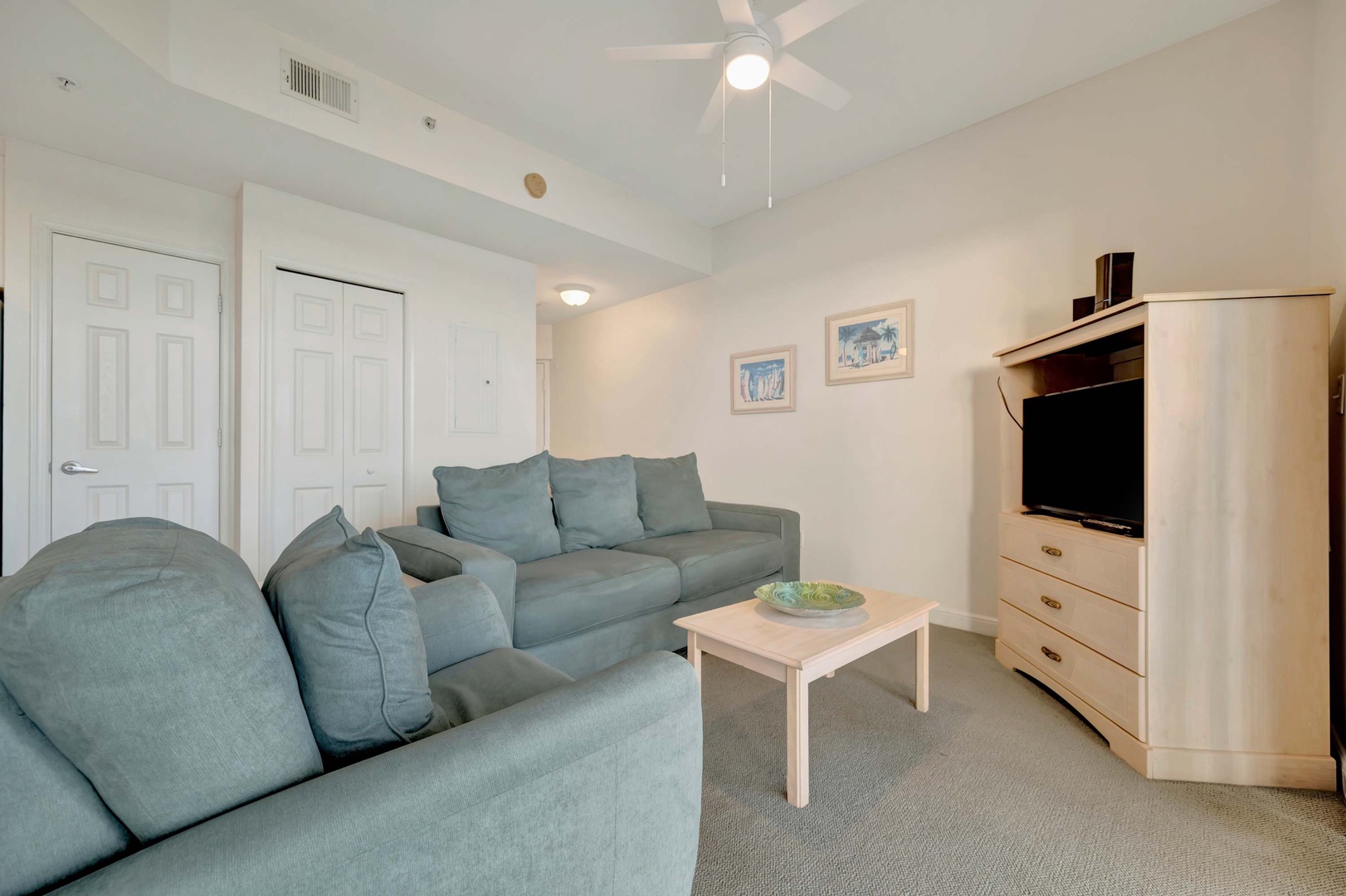 Unwind in your inviting living area, where plush teal sofas invite you to relax after a day of adventure. The airy vaulted ceiling and gentle fan keep you comfortable year-round.