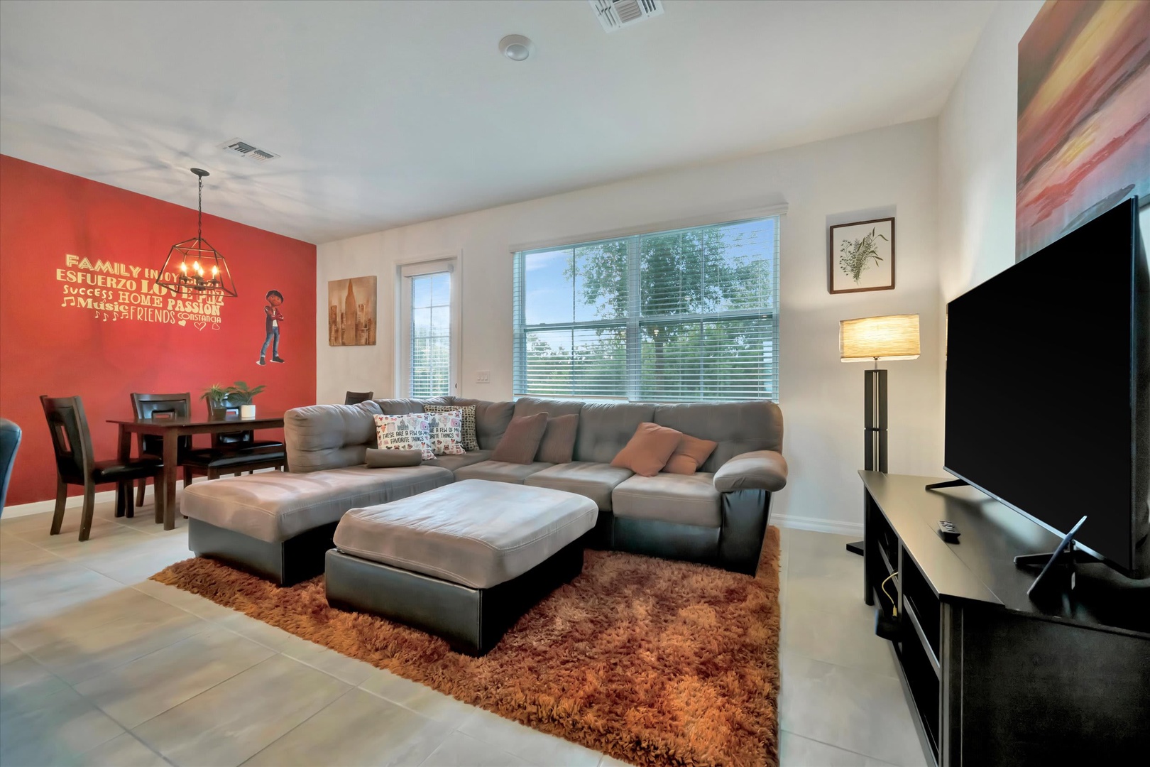 Unwind in your spacious living area with plush seating, warm lighting, and an open flow to the dining space—perfect for relaxing evenings or gathering with loved ones.