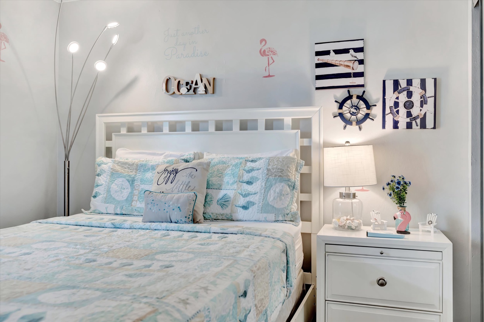 Drift off to sleep in this cheerful coastal bedroom, where soft blue linens and nautical accents create a serene, beach-inspired retreat just for you.