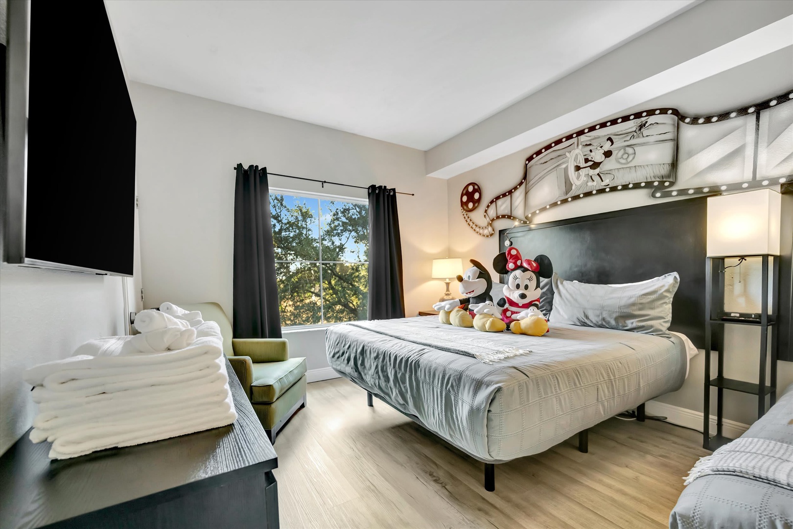 Step into your whimsical retreat where vintage movie magic meets modern comfort. Cozy beds, playful décor, and natural light set the stage for unforgettable family memories.