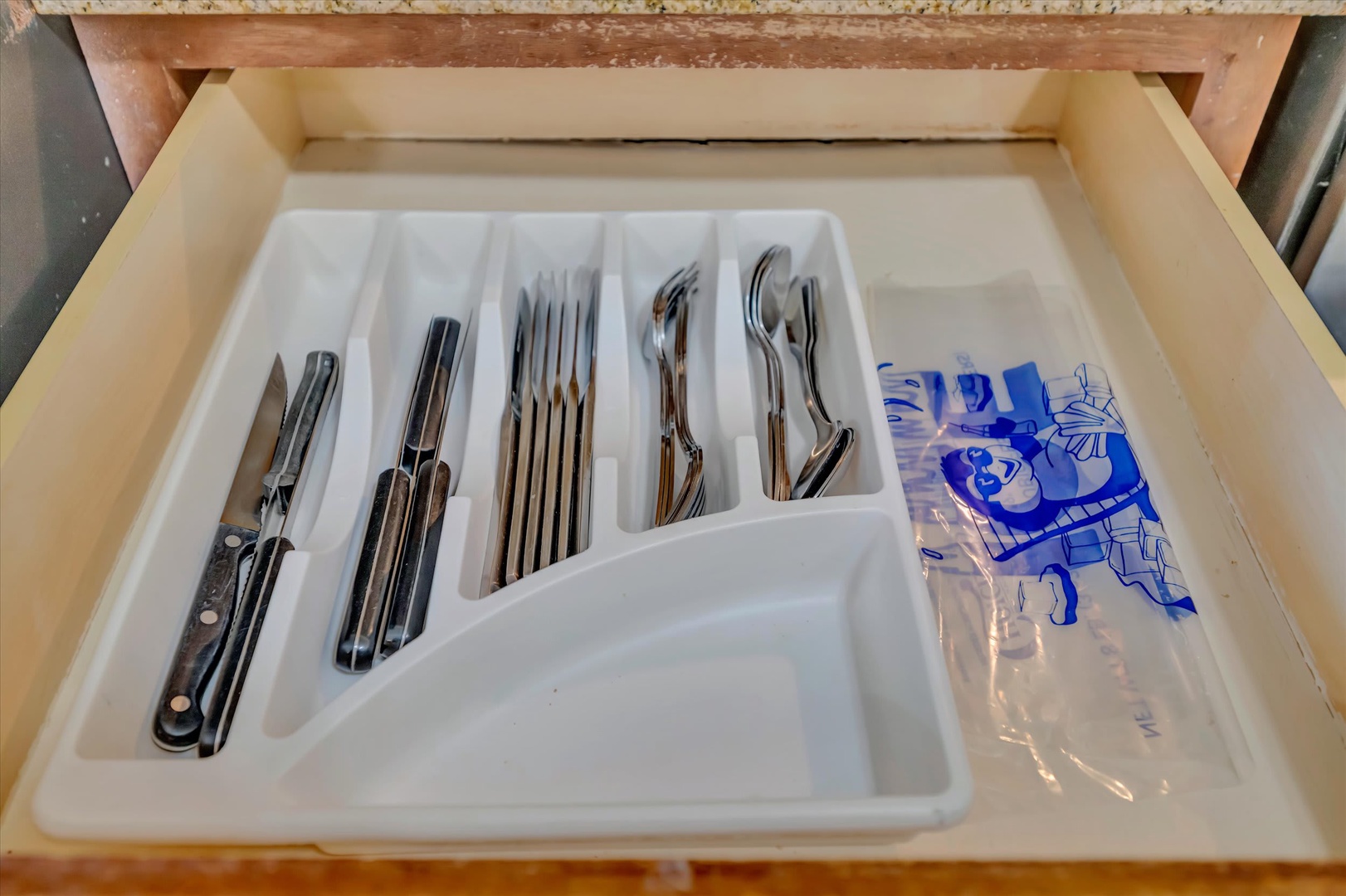 Your fully stocked kitchen drawer includes all the essentials—flatware, utensils, and even a corkscrew—so you can cook and dine in comfortably during your stay.