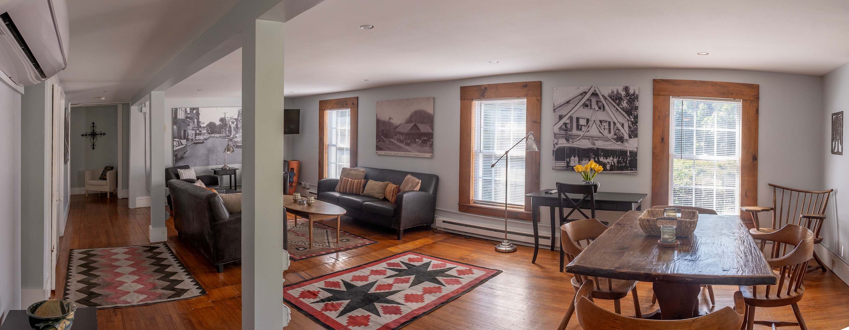 Your open-concept living and dining area offers hardwood floors, abundant natural light, and charming vintage-inspired décor. Relax by the windows or gather at the rustic table for memorable meals together.