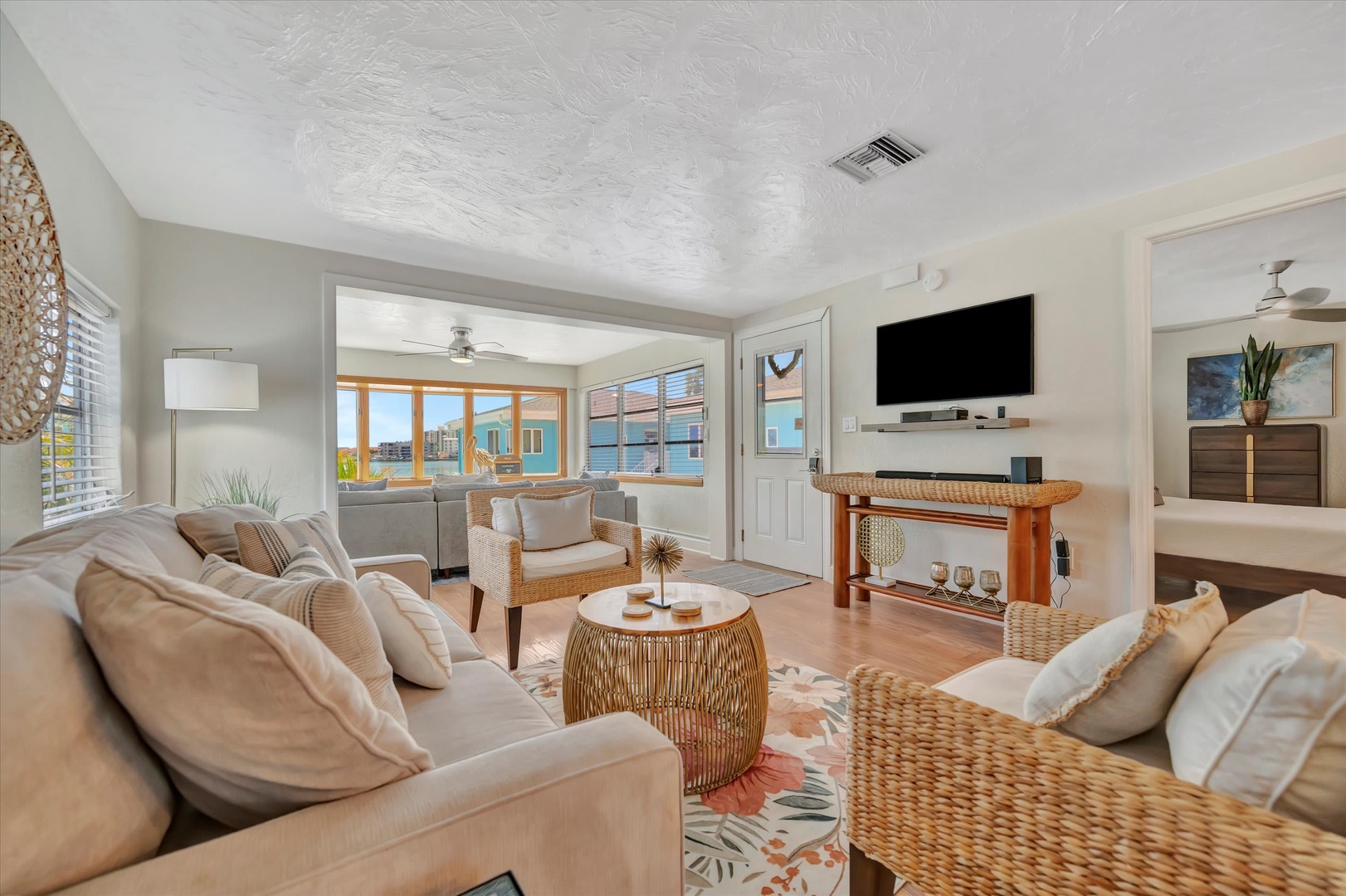 Your coastal retreat awaits with this airy, light-filled living space where natural textures and soft neutral tones create an inviting atmosphere. Settle in, unwind, and let the relaxed ambiance wash over you.