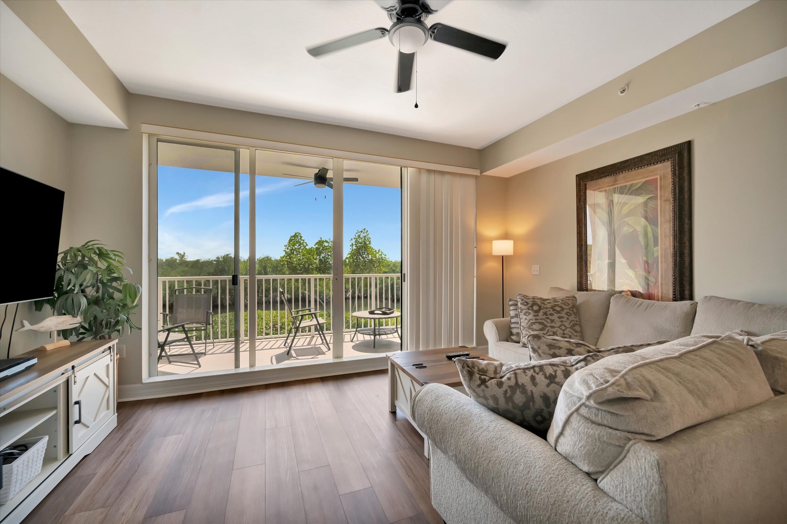 Sink into plush seating as your private balcony opens to refreshing treetop views and soft natural light floods your inviting living space.