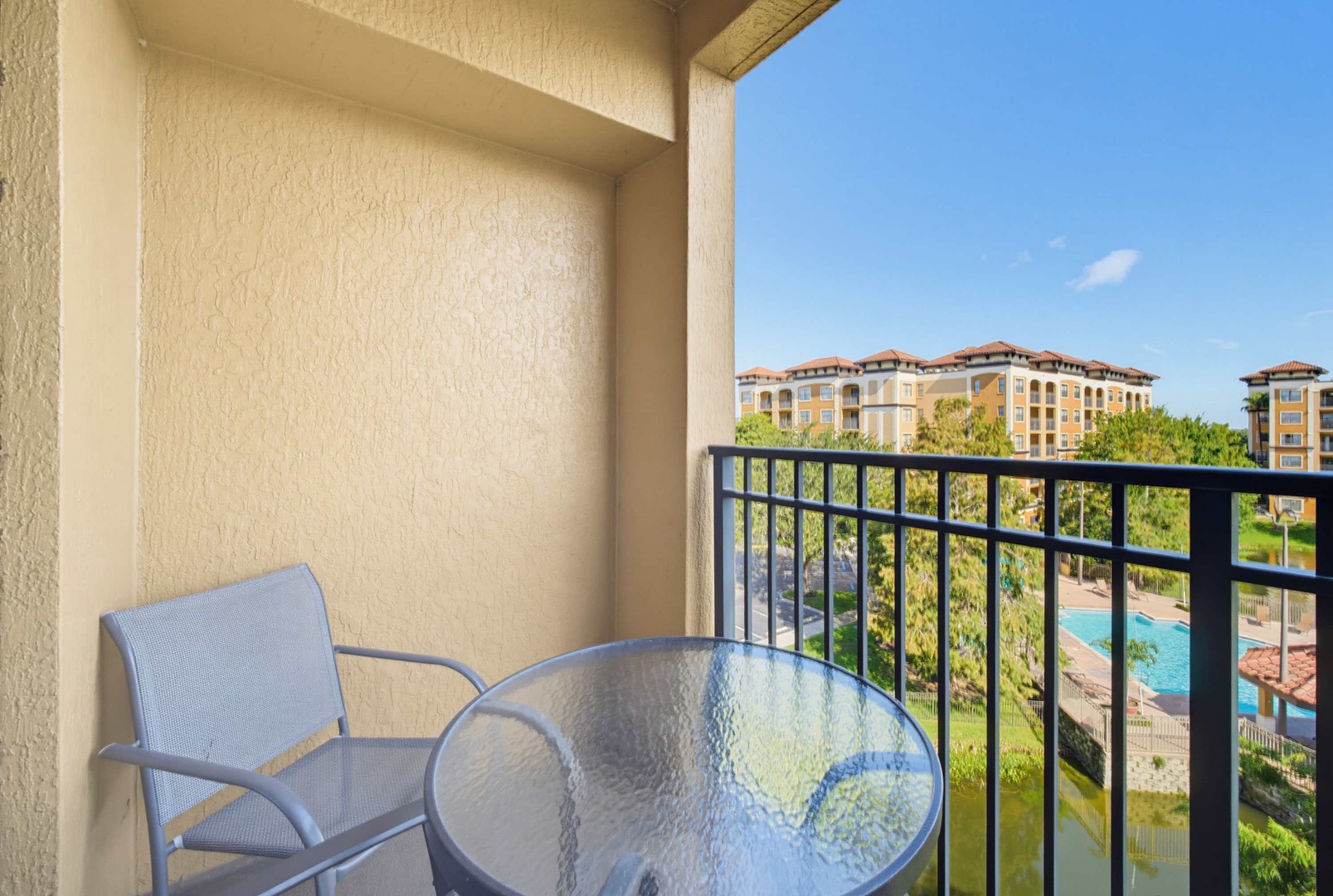 Step out onto your private balcony and soak in the sunny poolside views. Enjoy morning coffee at your own table with a gentle breeze and peaceful resort scenery all around.