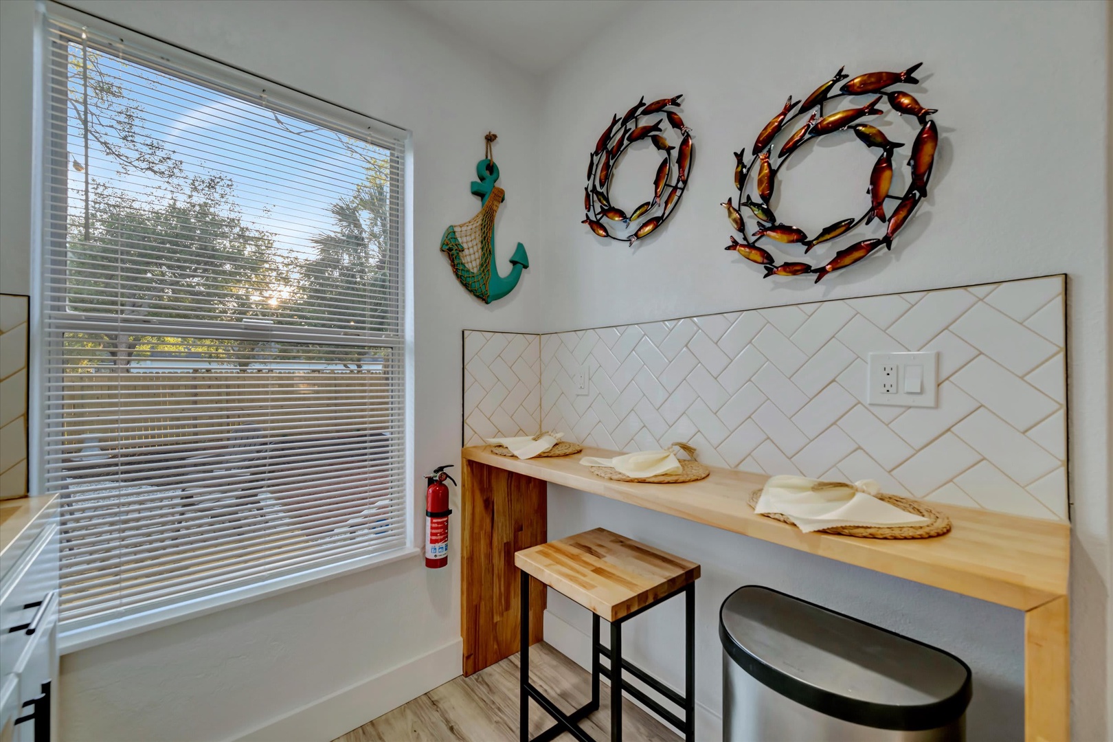 Relax at your private breakfast bar with coastal-inspired décor and natural light streaming through the window. Start your mornings with coffee while taking in the peaceful outdoor view.