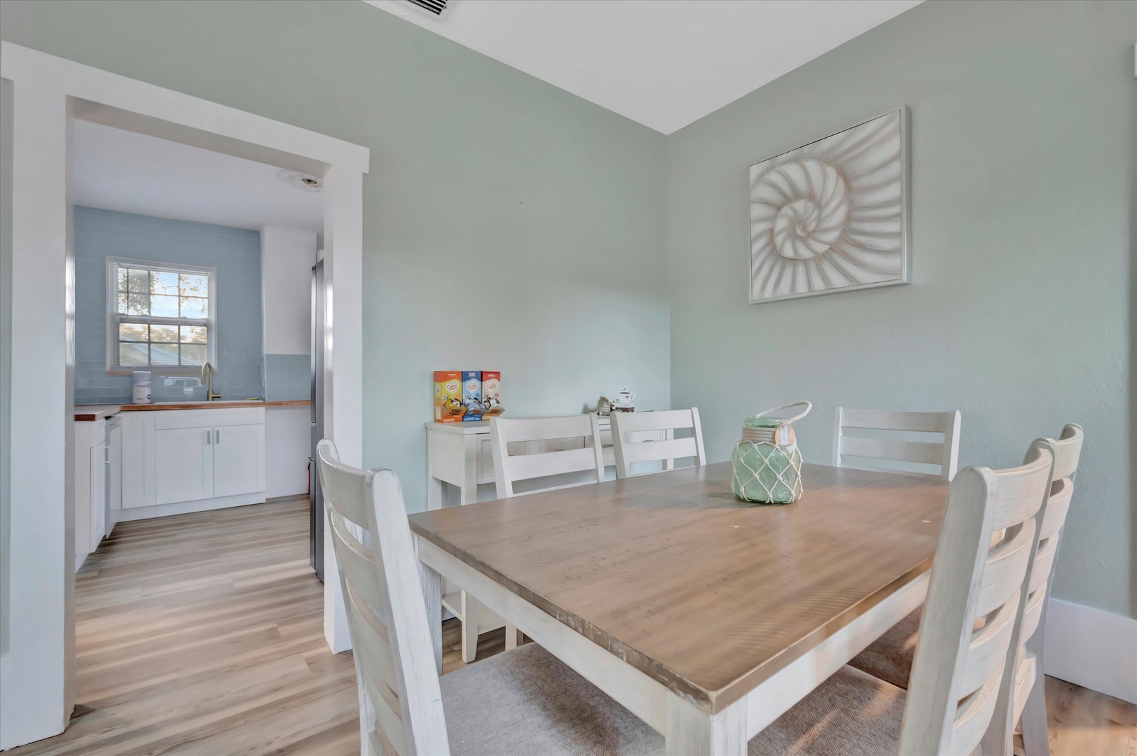 Gather around this inviting farmhouse-style dining table where your group can share meals and make memories together. The adjacent kitchen means easy serving and cleanup.
