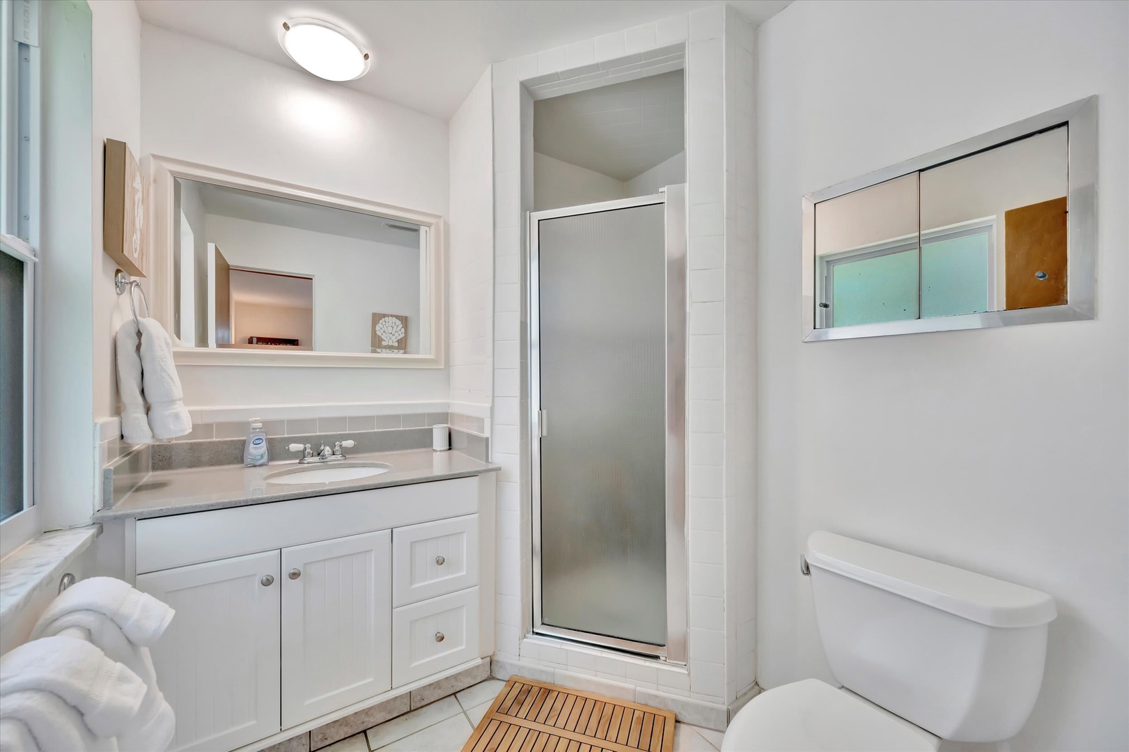 Step into your bright, refreshing bathroom with a walk-in shower, modern vanity, and fresh towels waiting for you—everything you need for a relaxing morning routine.