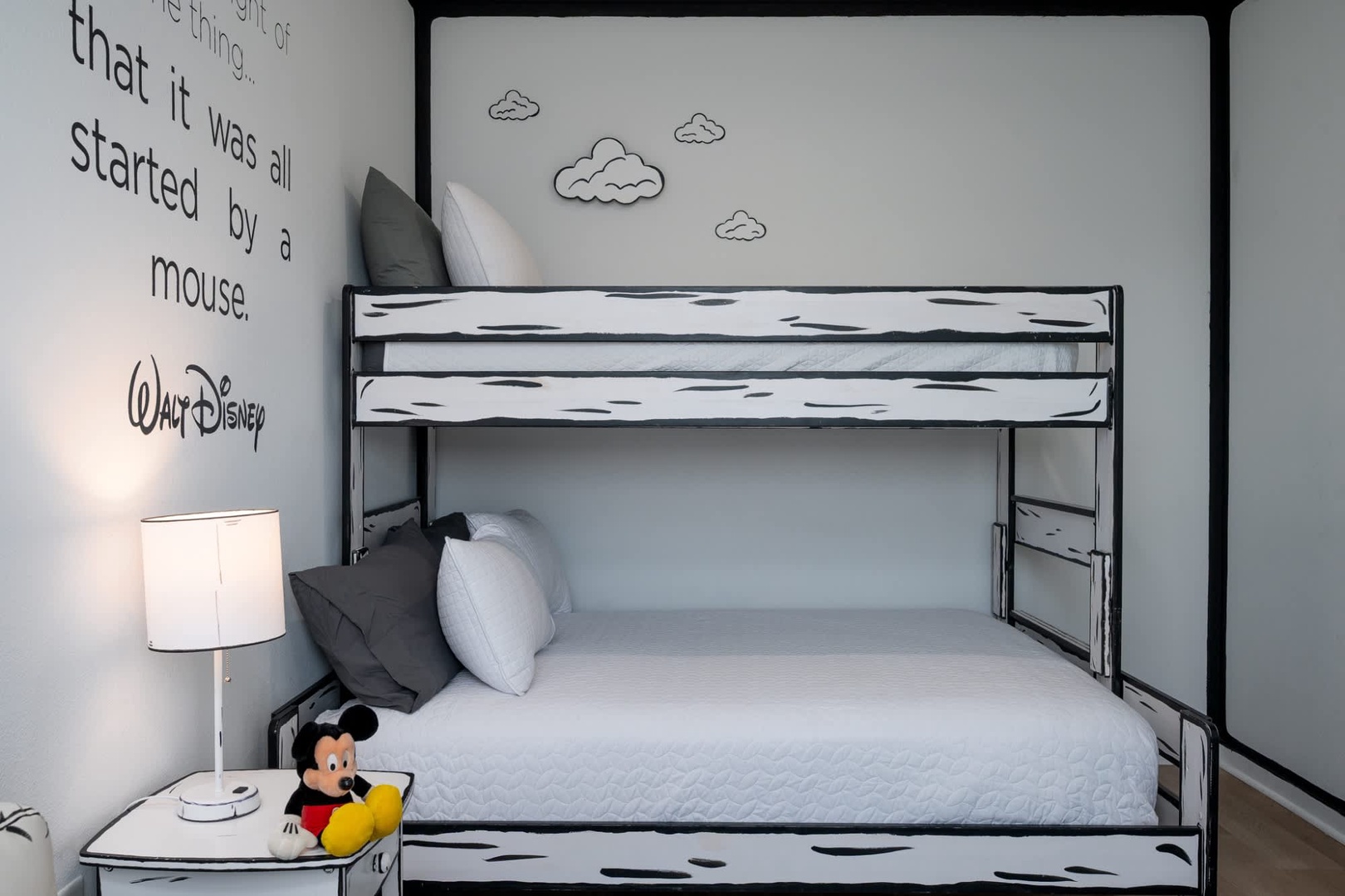 Your kids will love this whimsical cartoon-style bunk bed room with crisp white linens and playful cloud decals that spark imagination and adventure.