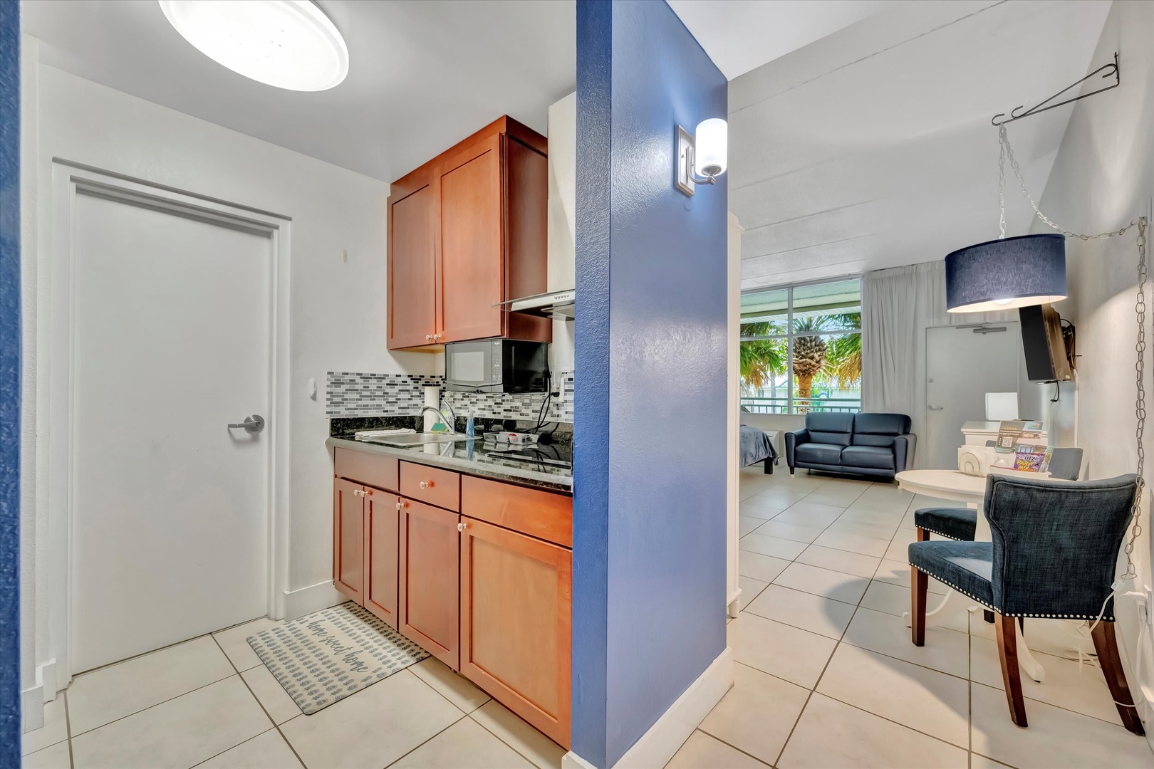 Your fully equipped kitchen flows seamlessly into the bright living area, perfect for preparing meals and gathering with loved ones during your stay.