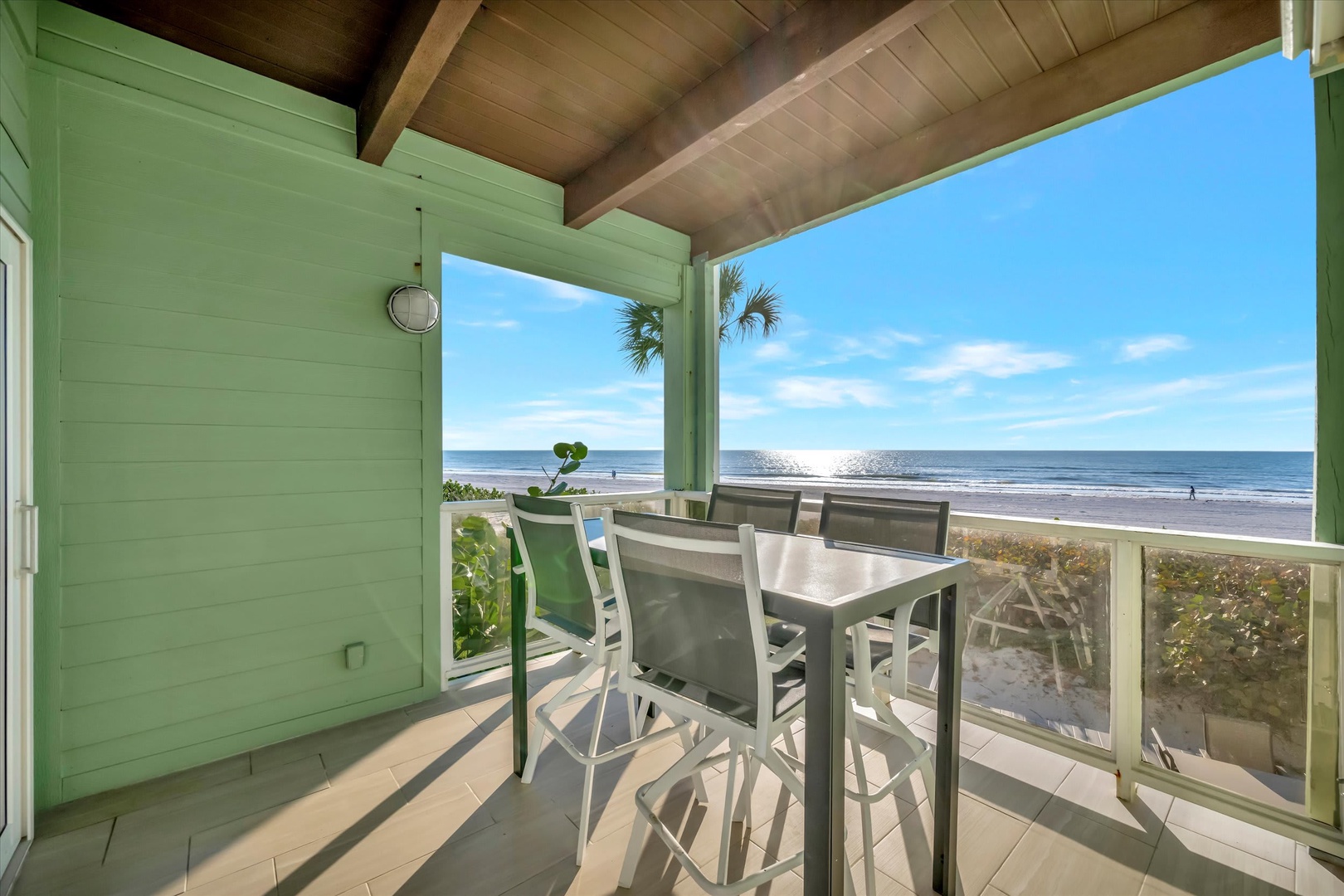Step onto your private balcony and soak in the stunning ocean view. Feel the sea breeze as you relax at the table, just steps from the sandy beach.