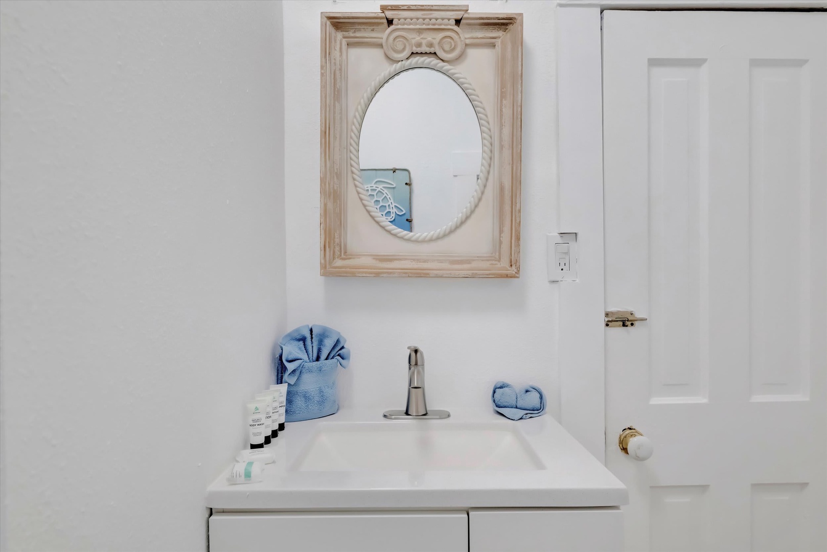 Freshen up in your coastal-inspired bathroom with nautical charm, soft towels, and complimentary toiletries ready for your arrival.