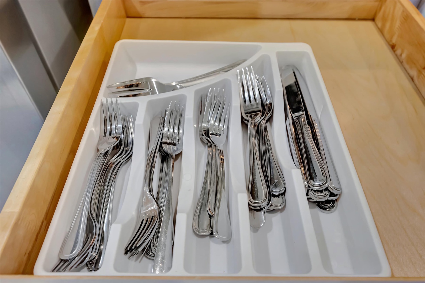 Your vacation rental comes fully equipped with polished silverware neatly organized in the kitchen drawer, ready for your use. Quality utensils and thoughtful details await your arrival.