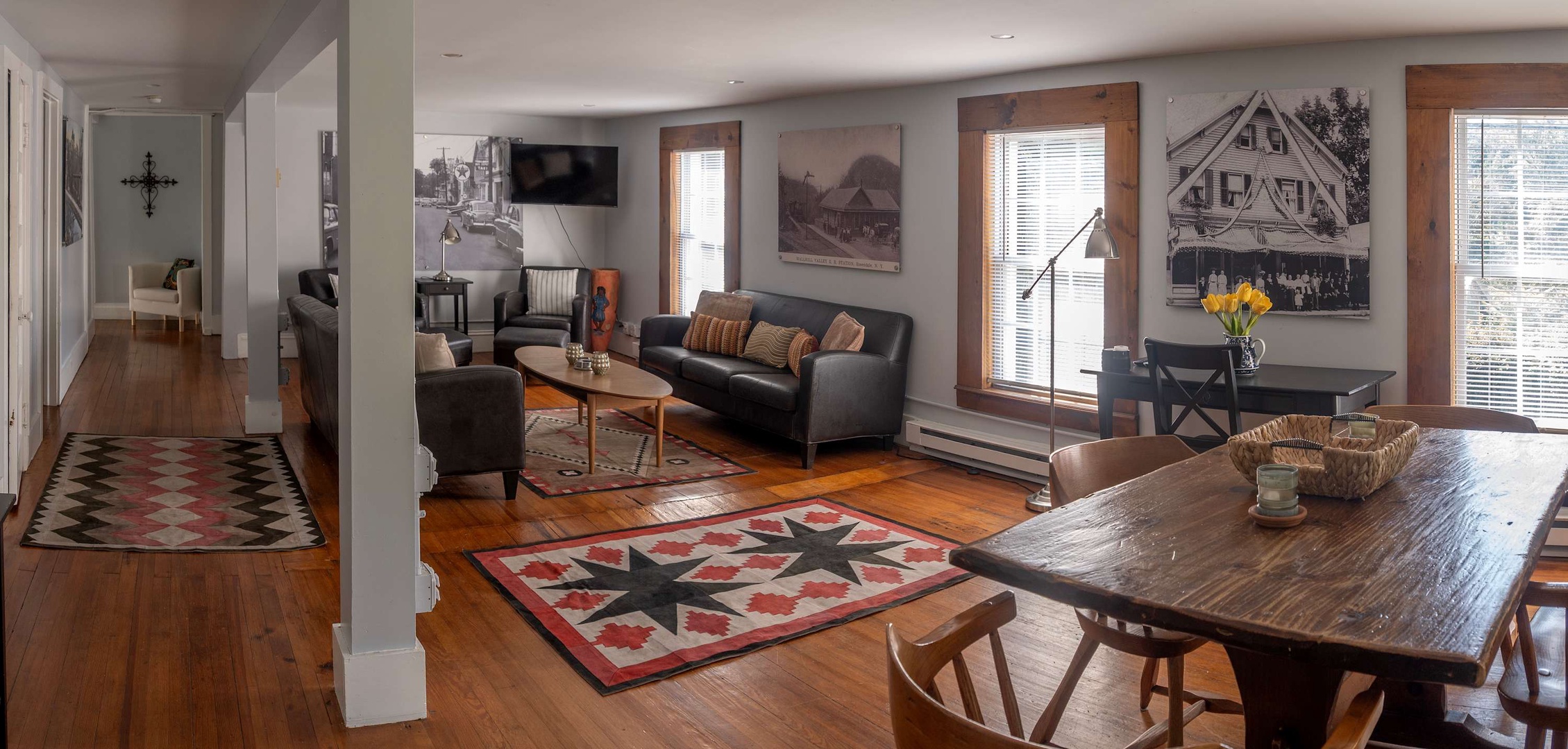 Step into a welcoming open-concept space where rustic wood floors, cozy leather seating, and charming vintage accents invite you to relax and make yourself at home.