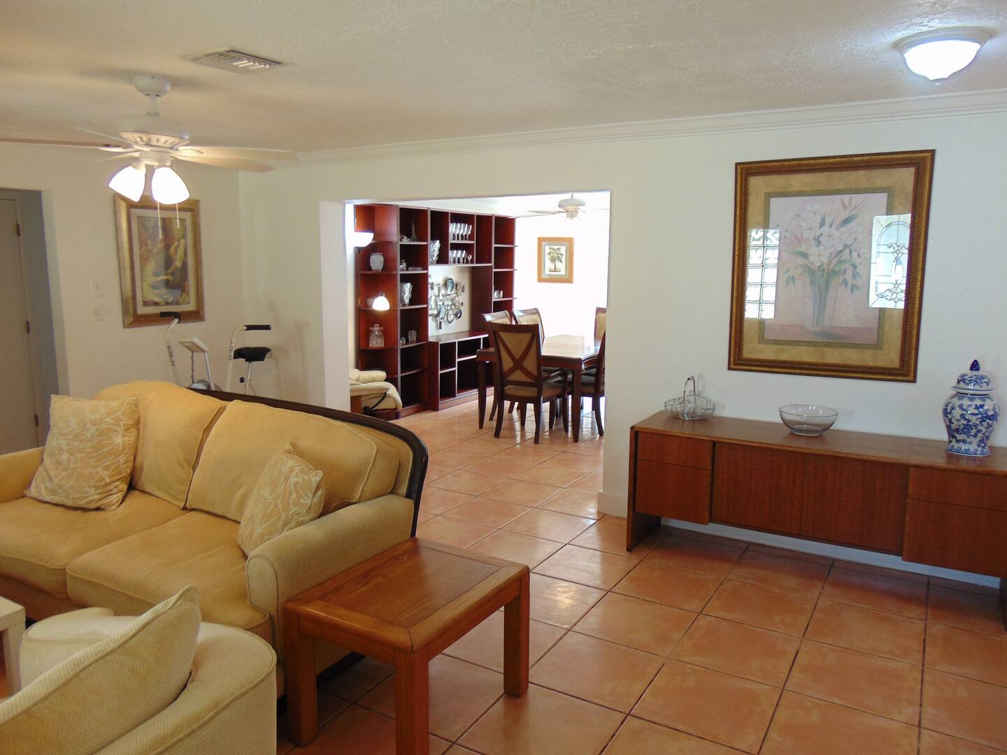 Step into your bright, welcoming living space with warm tile floors, plush seating, and an open flow that connects you to the dining area—perfect for unwinding or gathering with loved ones.