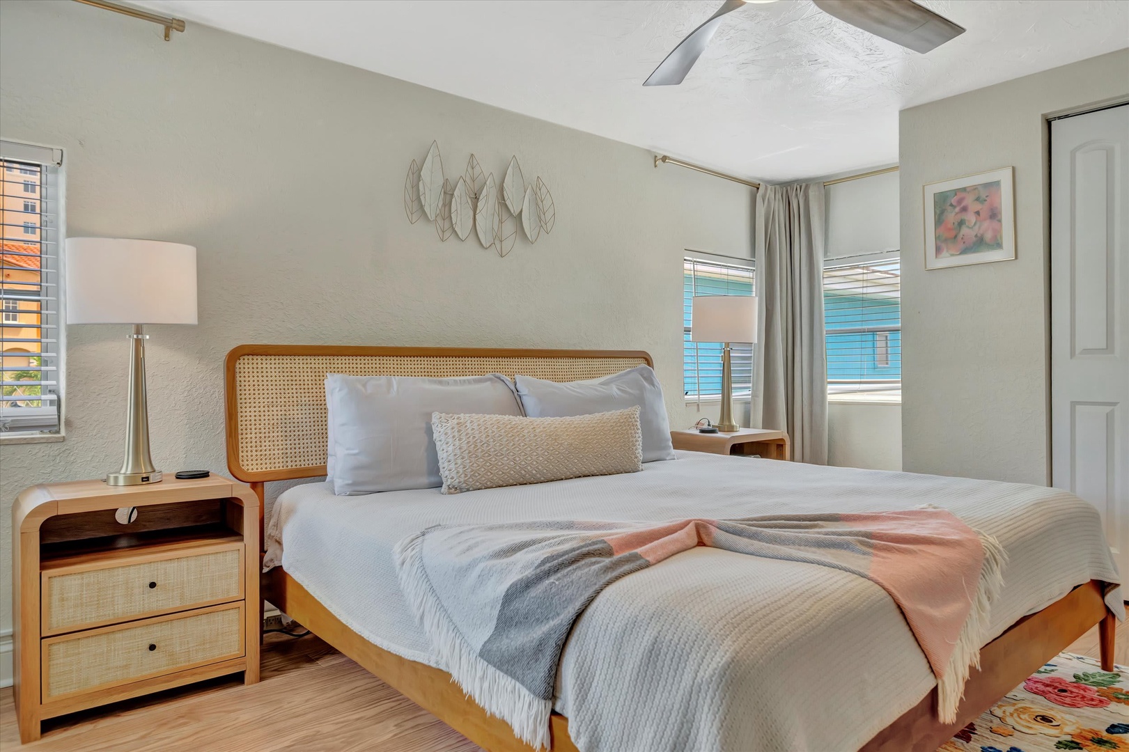Sink into plush bedding and let the coastal breeze lull you to sleep in your serene retreat, where natural textures and soft hues create the perfect sanctuary.