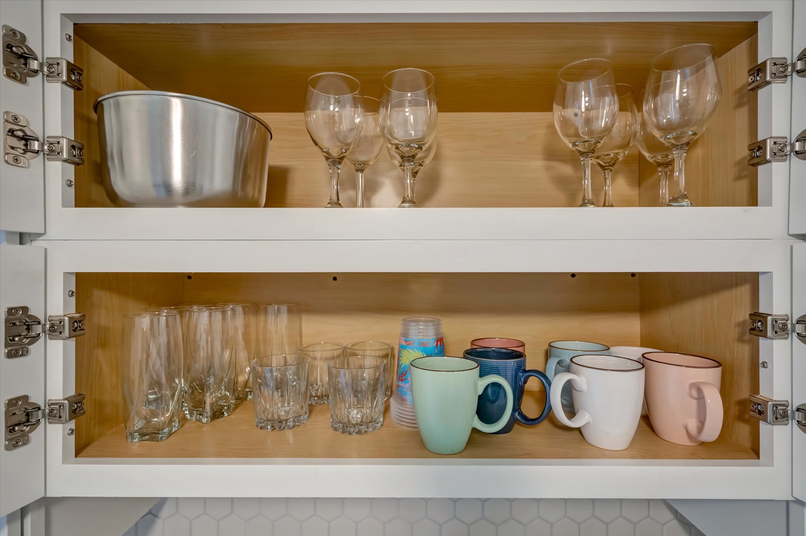 Your kitchen comes thoughtfully stocked with glassware and mugs for every occasion—wine glasses for evening toasts, tumblers for refreshing drinks, and colorful mugs for morning coffee.