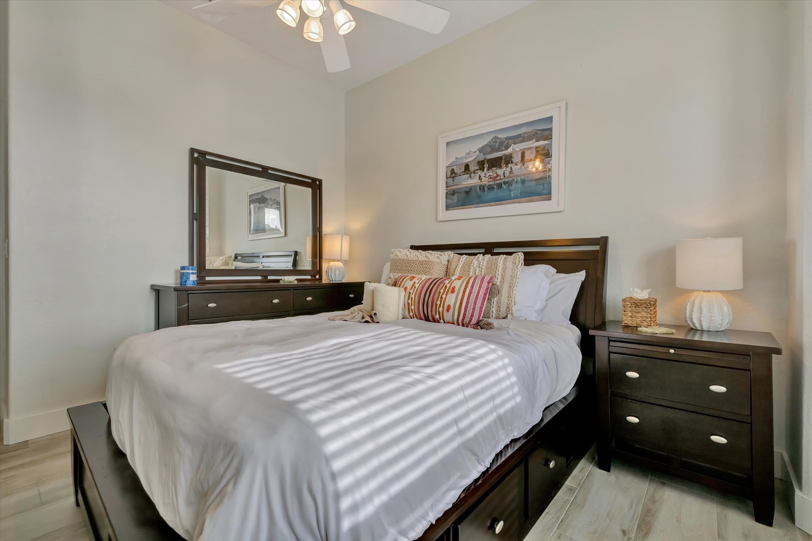 Step into your tranquil bedroom retreat with crisp white linens, warm wood furnishings, and soft lighting that invites you to unwind after a day of adventure.