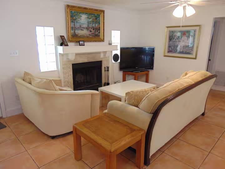 You'll love unwinding in this inviting living room, featuring plush seating arranged around a cozy fireplace and entertainment area—perfect for relaxing evenings after your daily adventures.