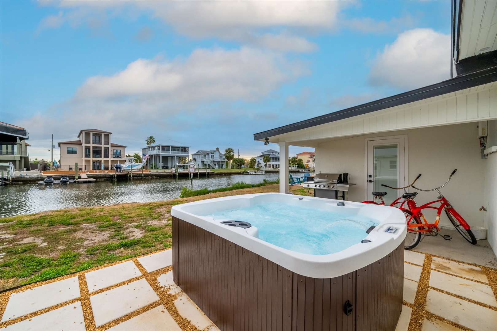 Unwind in your private hot tub with serene waterfront views—perfect for soaking away the day while you enjoy the coastal atmosphere and neighborhood charm.