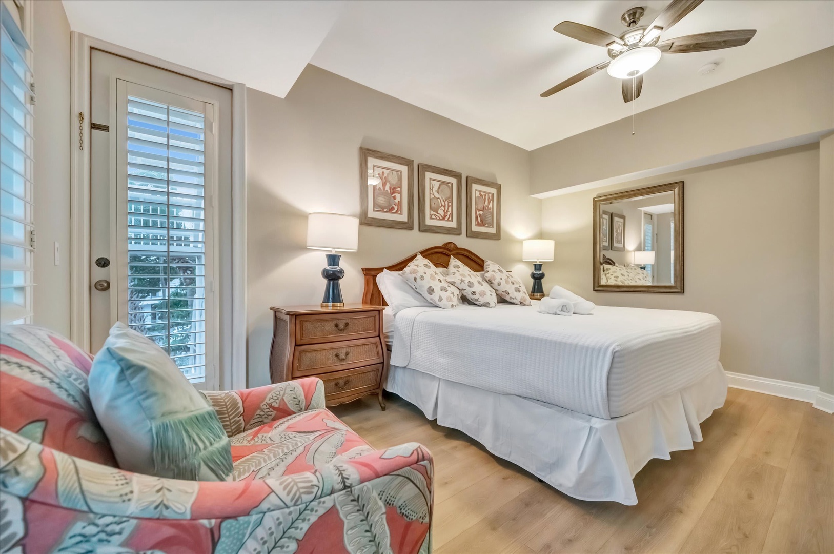 Your restful retreat awaits, with soft linens on a welcoming bed, a cozy reading chair, and gentle ceiling fan breezes to help you unwind completely.