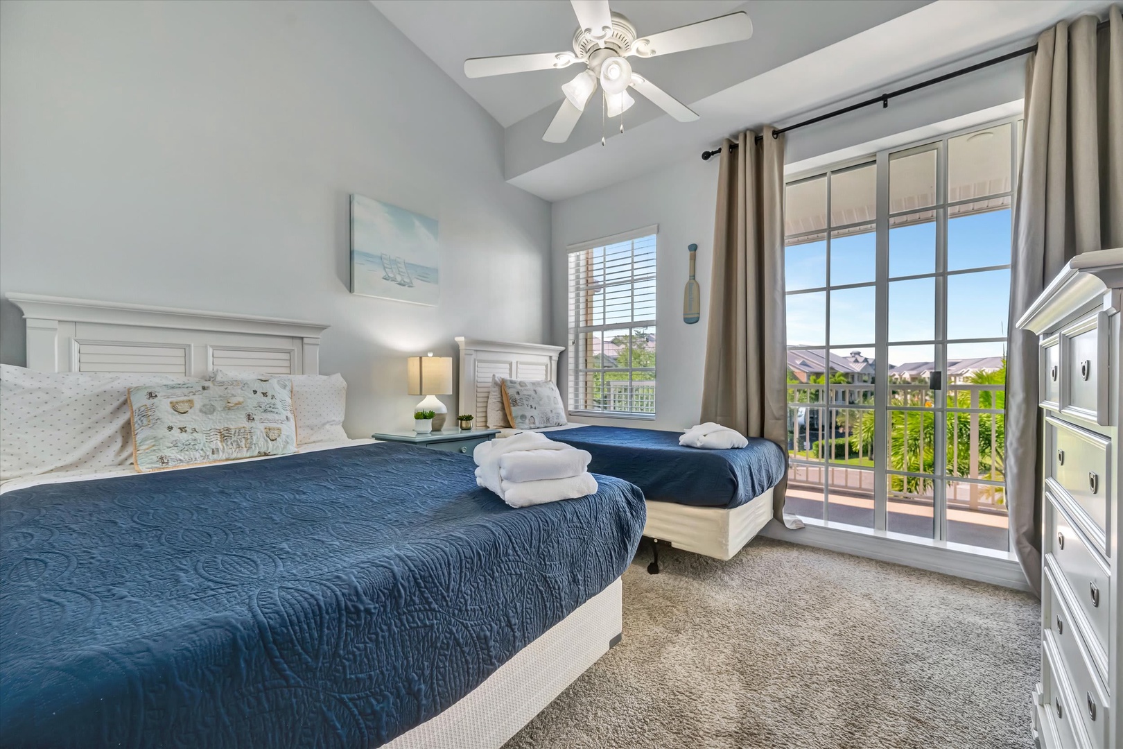 Wake up refreshed in this serene bedroom with twin beds and your own balcony access. Fresh towels and neighborhood views await you each morning.