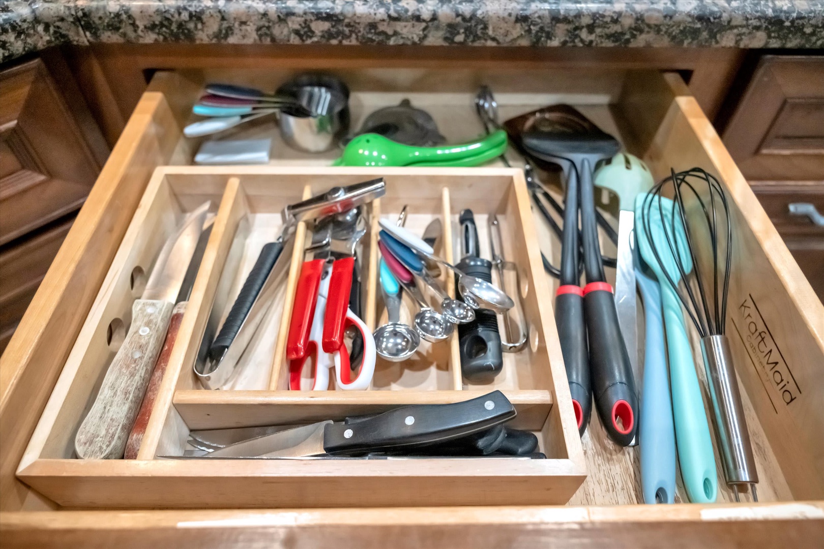 Your kitchen is fully equipped with all the tools you need to prepare delicious meals, from sharp knives and whisks to spatulas and serving utensils, all organized and ready for your culinary adventures.