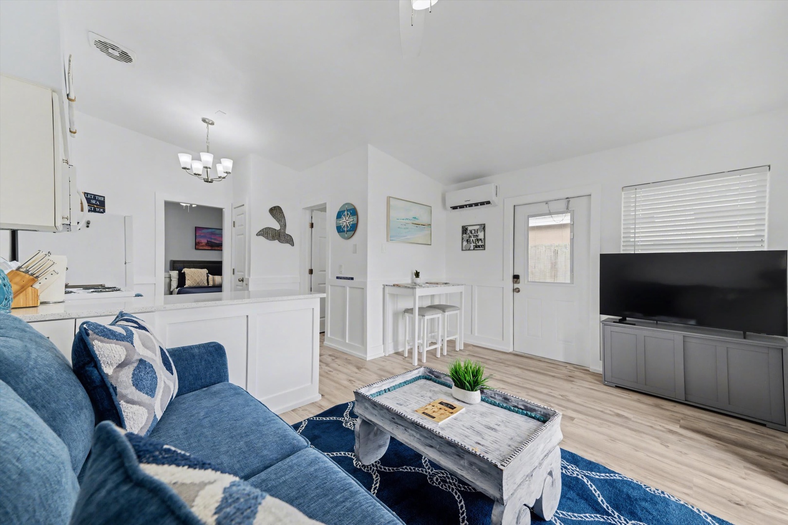 Settle into your bright, coastal-inspired retreat with nautical touches and airy open-plan living. This inviting space offers a fully equipped kitchen, cozy seating, and modern comforts—perfect for unwinding after a day of adventure.