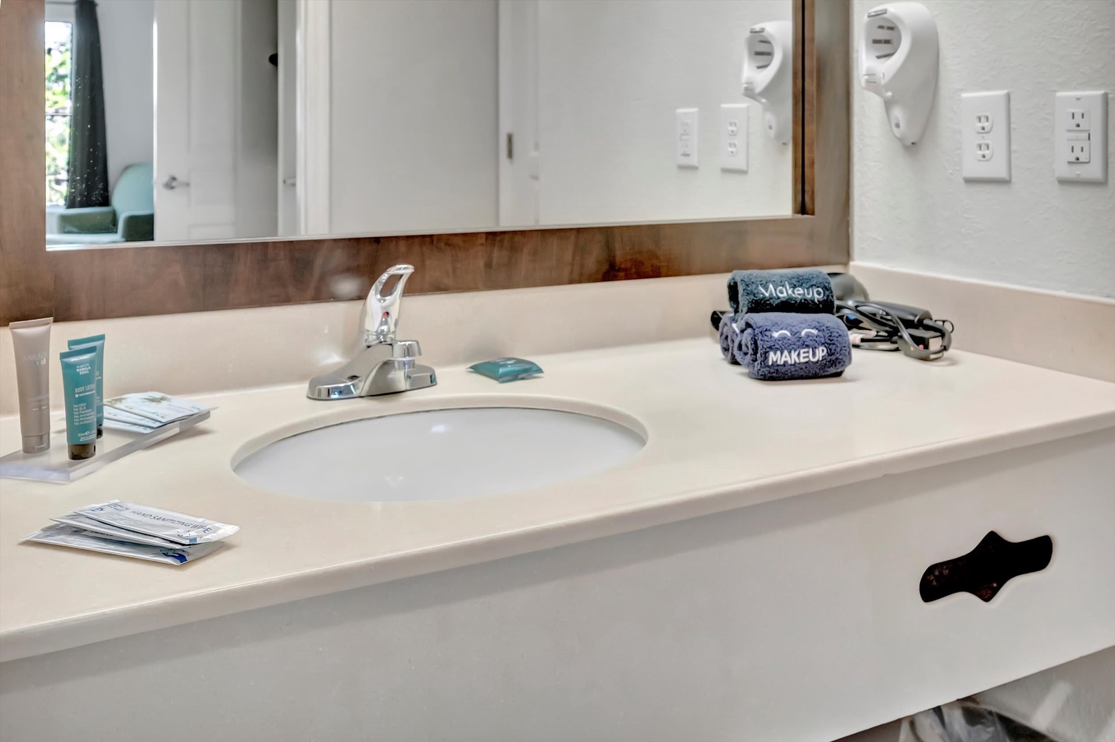 Your bathroom vanity is stocked and ready—fresh toiletries, a hairdryer, and plenty of counter space to spread out and settle in after a long day.