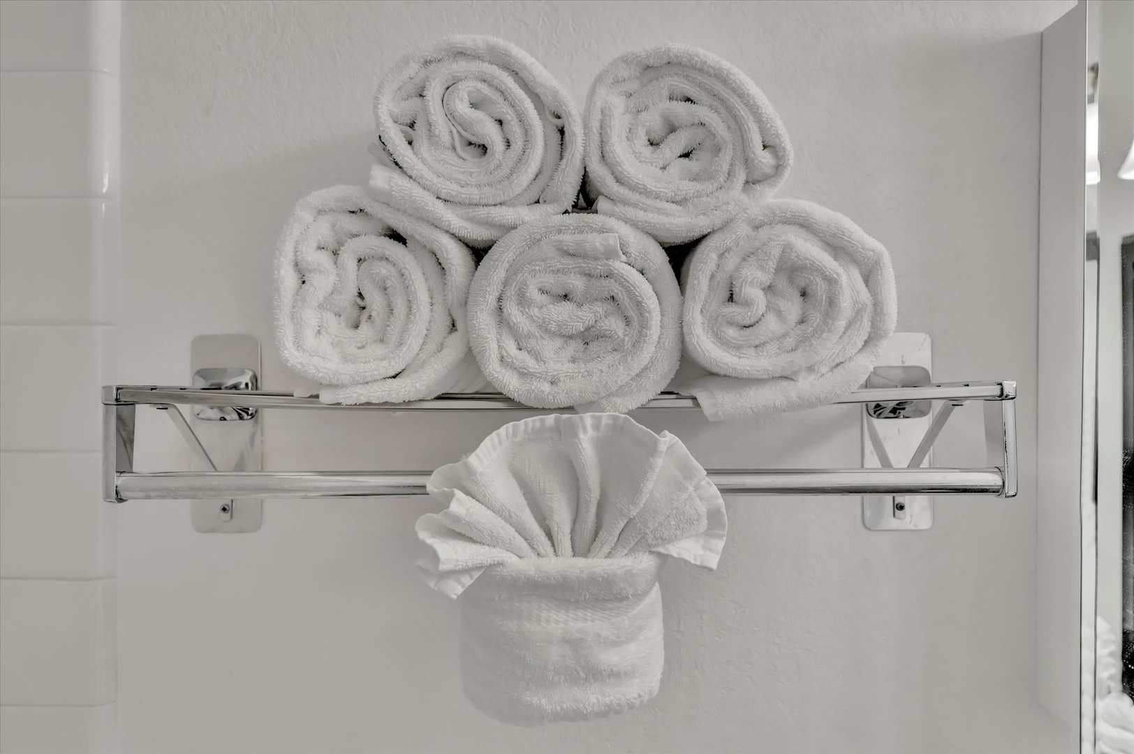 Fresh towels await you in the bathroom, crisply rolled and elegantly displayed—a thoughtful touch to help you feel pampered and at home.