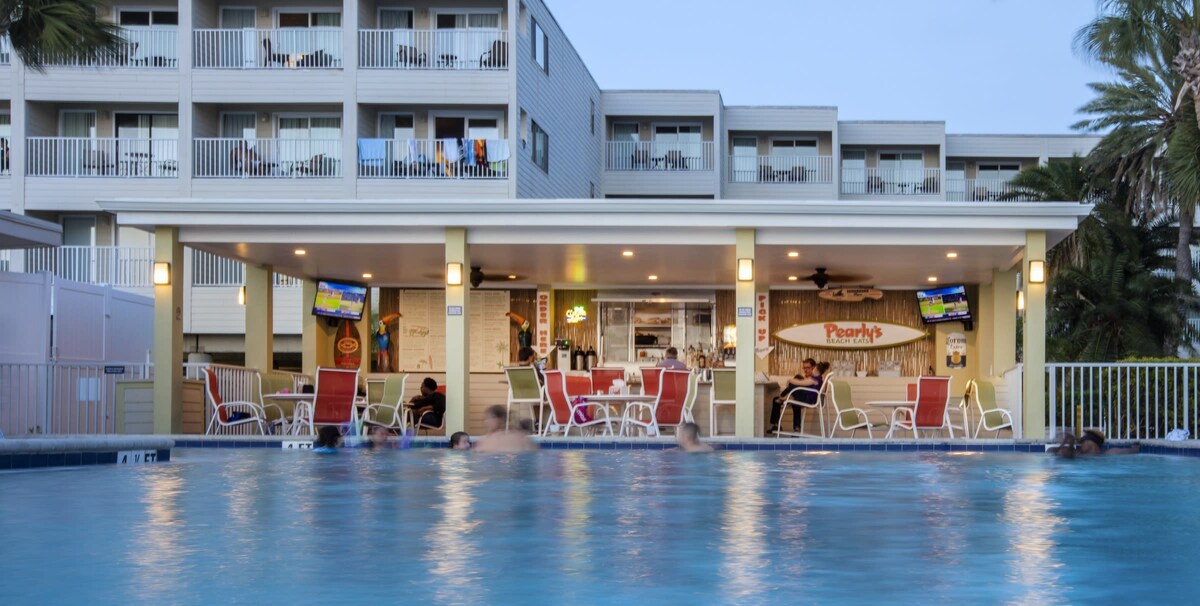 Unwind poolside at the covered pavilion bar with tropical vibes, comfortable seating, and refreshments just steps from your room.
