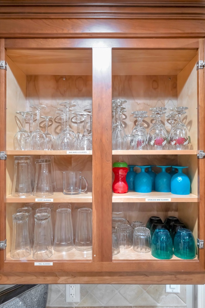 Your cabinet is thoughtfully stocked with an array of glassware—from wine glasses to tumblers and colorful drinkware—ready for every occasion during your stay.