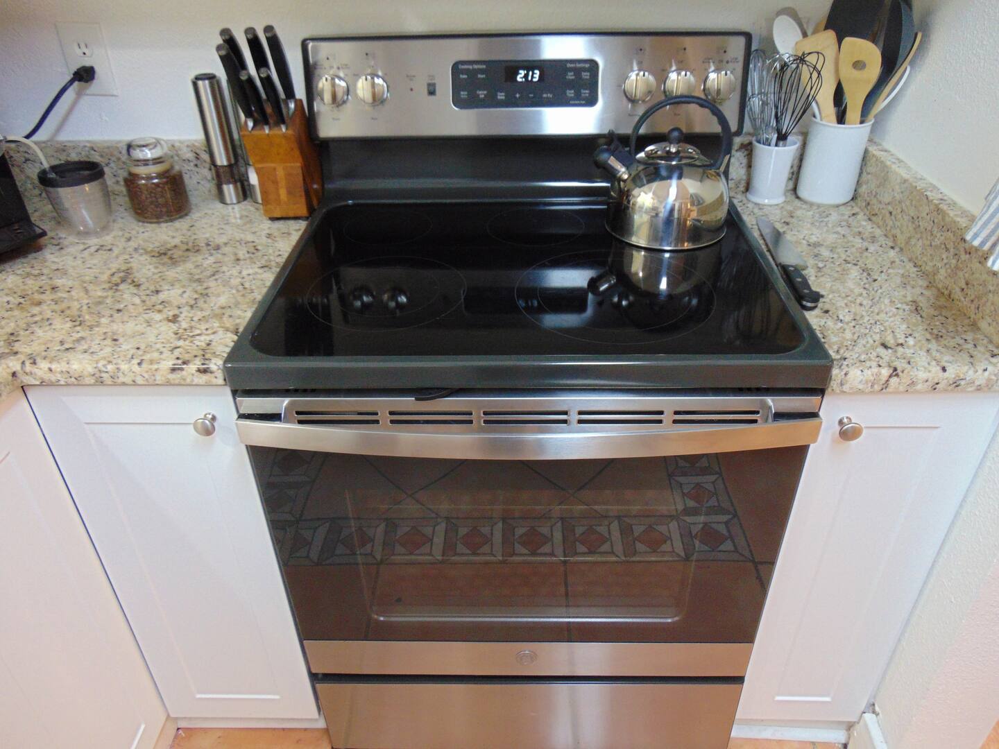 You'll love preparing meals on this modern stove with a sleek glass cooktop, set into beautiful granite counters. The fully equipped kitchen makes cooking a breeze during your stay.