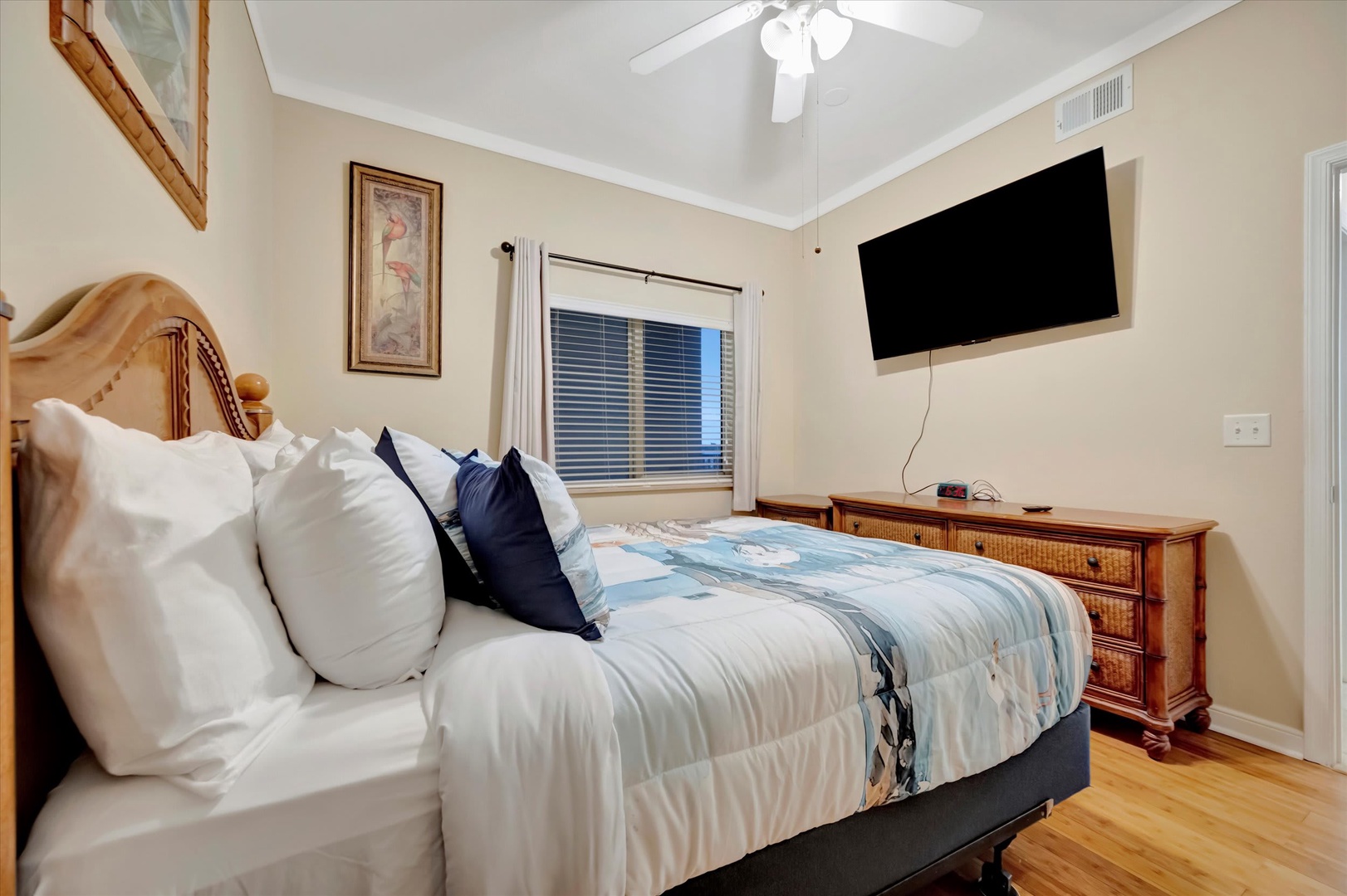 Sink into plush bedding and unwind in your peaceful bedroom, where vaulted ceilings and coastal charm invite you to relax after a day of exploration.
