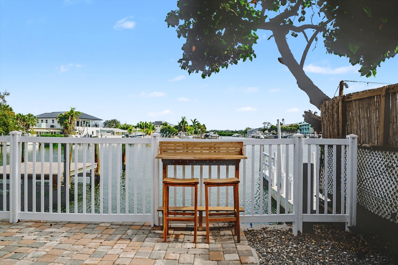 A waterfront patio with charming bar seating and canal views—your perfect spot for morning coffee or evening cocktails under the Florida sun.