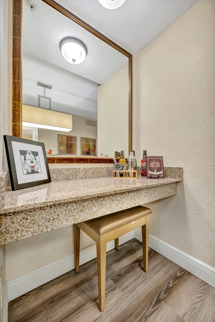 Your private vanity nook awaits—take your time getting ready at this dedicated space with natural stone countertop and warm lighting.