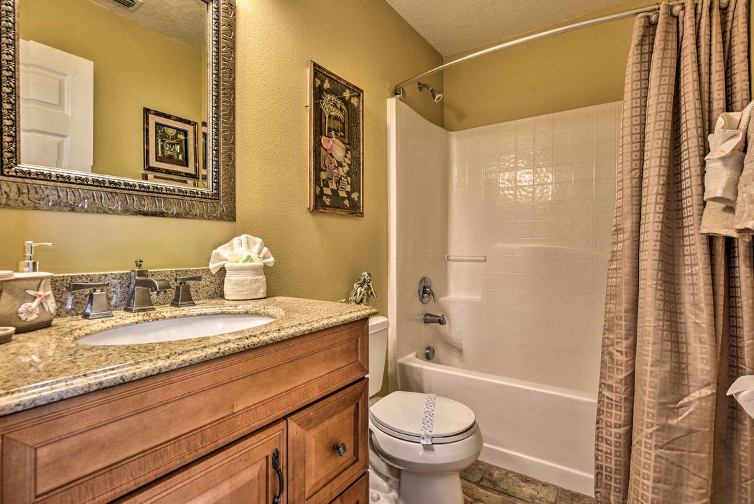 Your private bathroom features warm tones and thoughtful touches—fresh towels await, and everything you need is right here for a relaxing stay.