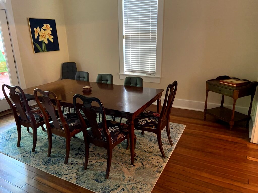 Gather around this beautiful dining table for memorable meals together. The elegant wood furniture and warm hardwood floors create an inviting space where your group can share stories and laughter.