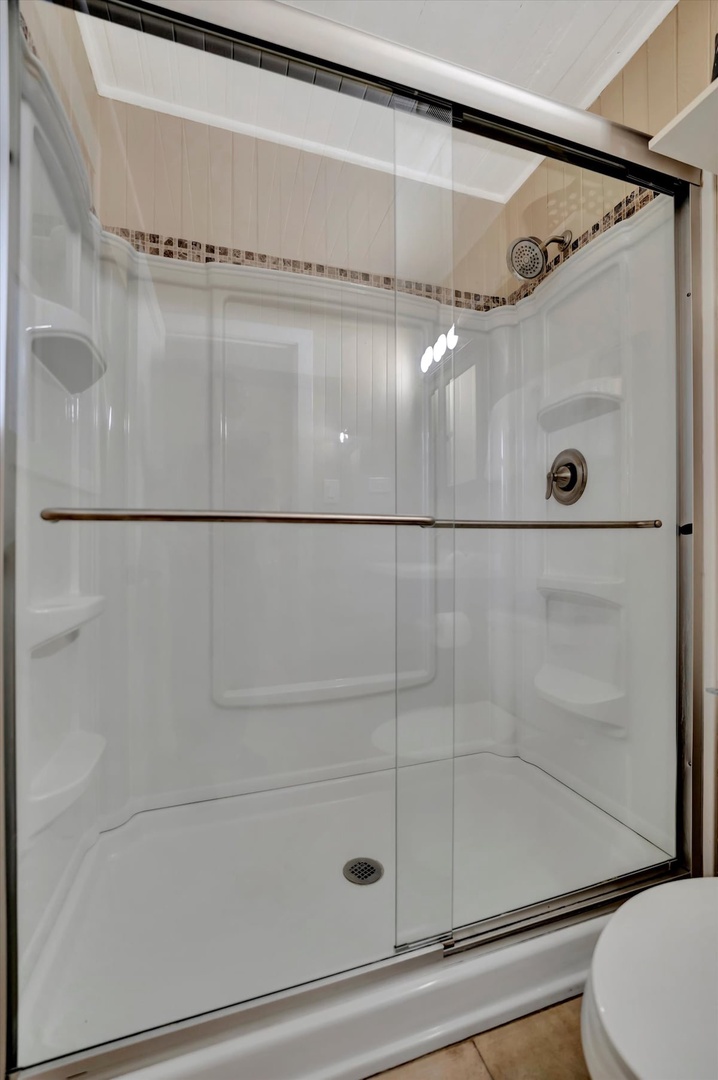Refresh with ease in your sleek, modern shower featuring a spacious walk-in design and elegant glass doors that keep everything bright and welcoming.