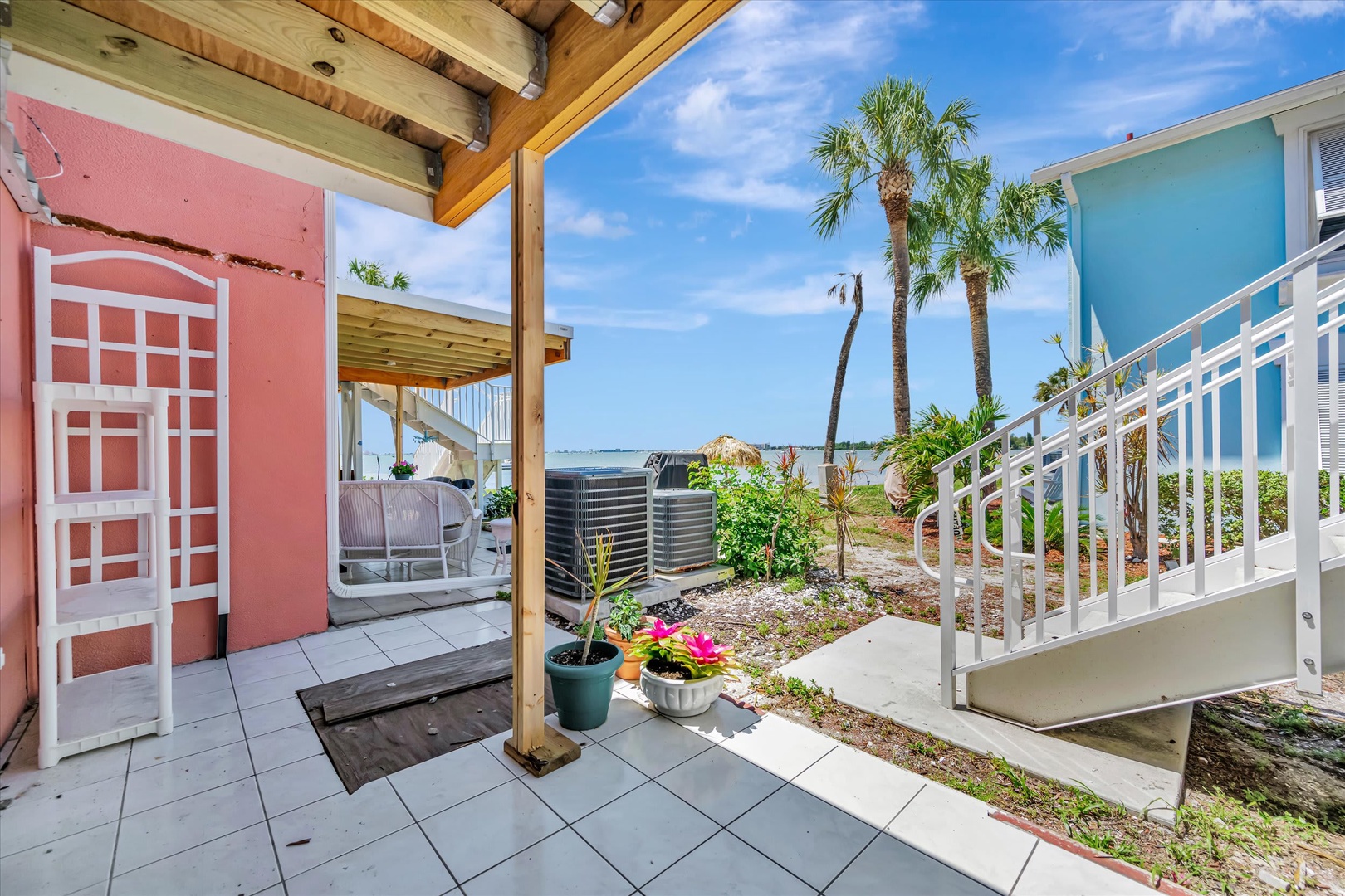 Colorful cottages framed by swaying palms and glimpses of calm waterfront create a tropical retreat where island charm meets coastal tranquility.